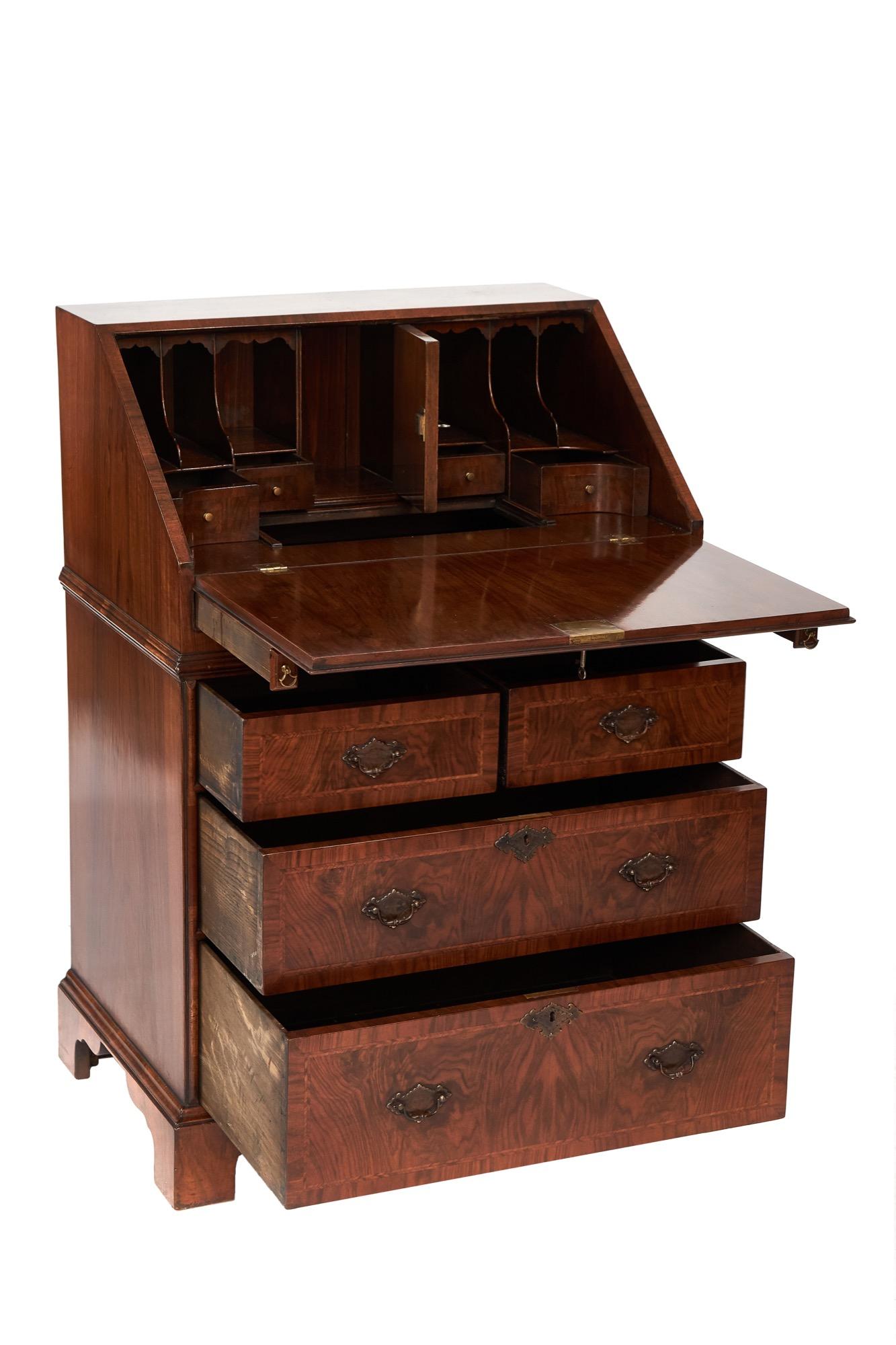 Queen Anne Revival Walnut Bureau circa 1920s, 
figured walnut veneers
shaped interior with drop well compartment, 
4 drawer base, 
Herringbone inlay on fall & drawer fronts
[Floor to top of writing flap 76cm ]

William & Mary, Queen Anne & Georgian