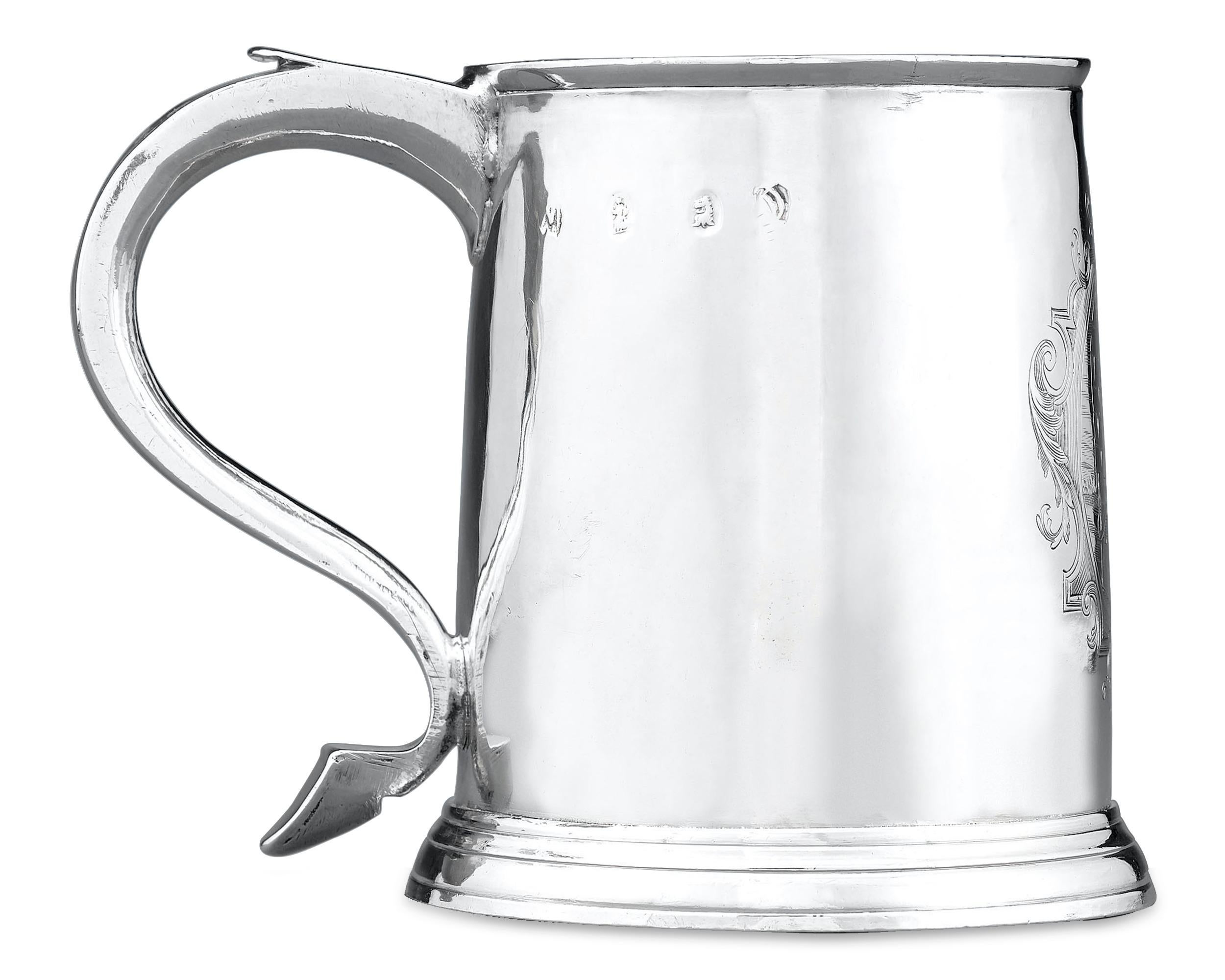 This fine English silver half-pint mug from the Queen Anne period bears the mark of London silversmith John Wisdome. The elegantly tapered, cylindrical form boasts a curious and marvellously detailed engraving of a Chinese gentleman in his native