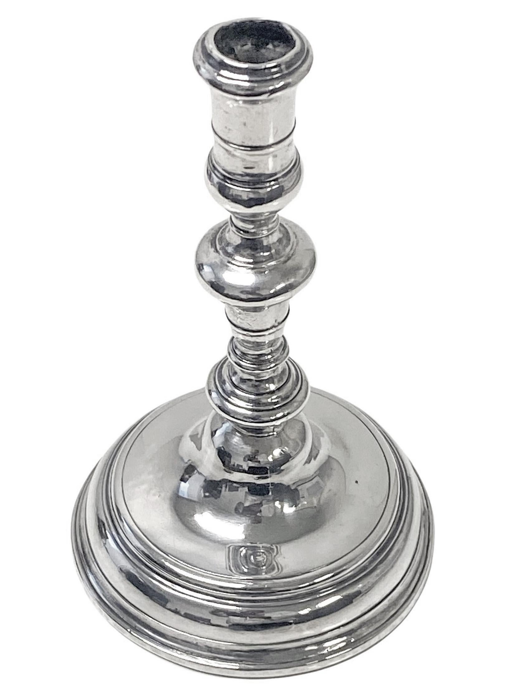 Queen Anne silver taperstick London 1704 Richard Syngin (Syng). The taperstick of plain early design with knopped stem and moulded circular base. Britannia standard silver.  Weight 106 grams, 3.40 troy ounces. Height 10.7cm. Base diameter 7.0cm.