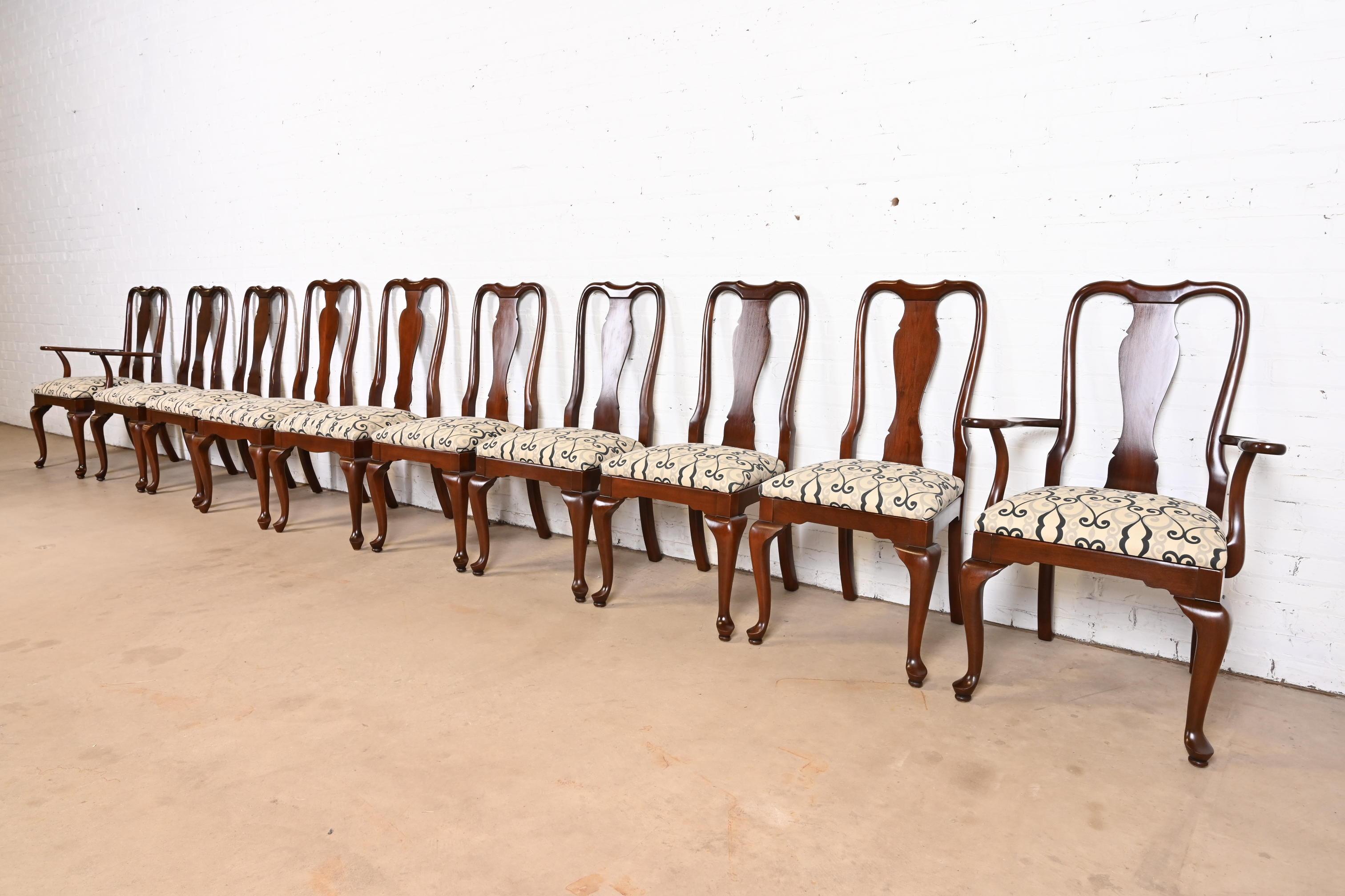 An exceptional set of ten Queen Anne or Georgian style dining chairs

USA, Late 20th Century

Solid sculpted cherry wood frames, with upholstered seats.

Measures: 
Side chairs: 20.5