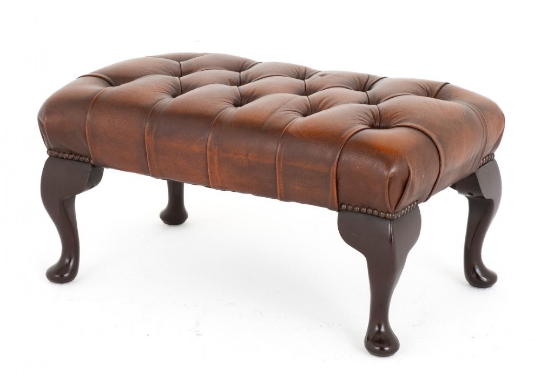 Queen Anne Style Leather Footstool. 
The Stool Stands Upon Cabriole Legs. 
Circa 1930
The Stool Features a Deep Buttoned Seat With Brass Stud Work Detail. 
The Leather Has a Wonderful Antique Finish.
