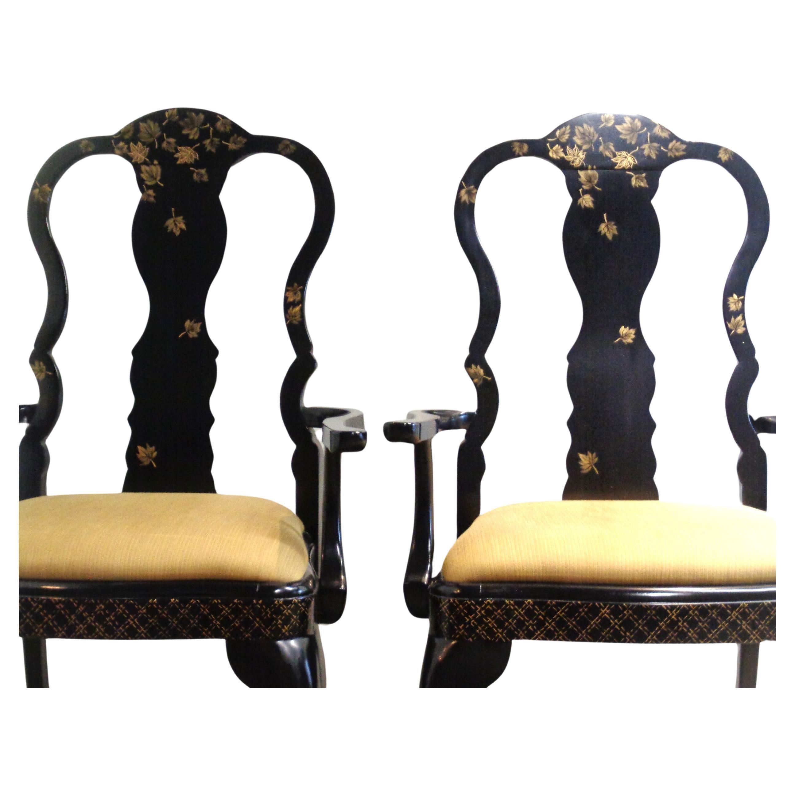 A pair of Queen Anne style black lacquered armchairs in all original beautiful glowing surface w/ finely gilded chinoiserie decoration of floating leaves and cross hatching. Measure 42 1/2