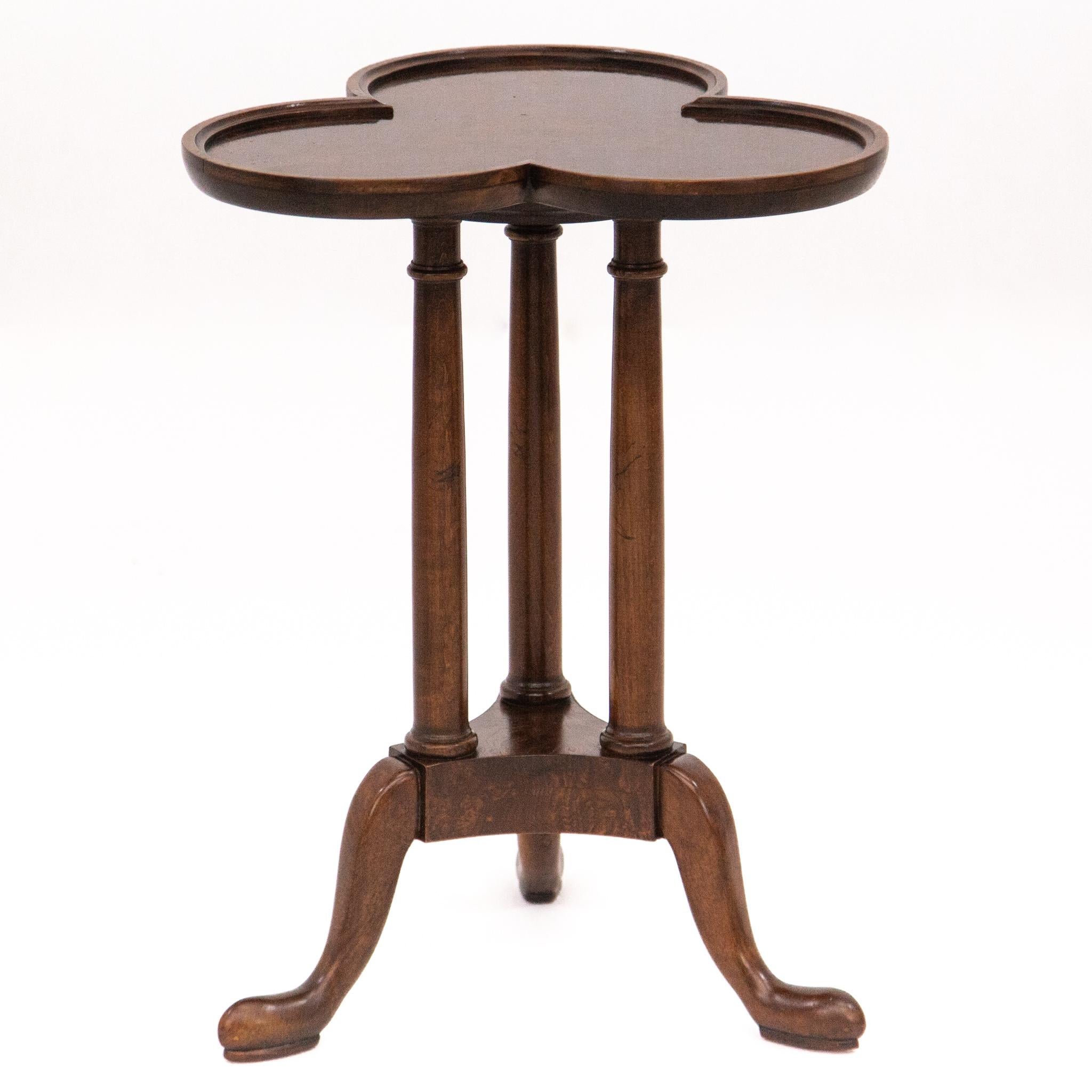 Beautifully detailed Queen Anne style walnut drinks table, accent table or candle stand with three-lobed burl top above a tripod pedestal base. Made by Baker Furniture, circa 1960s. It is in excellent vintage condition with very minimal age wear.