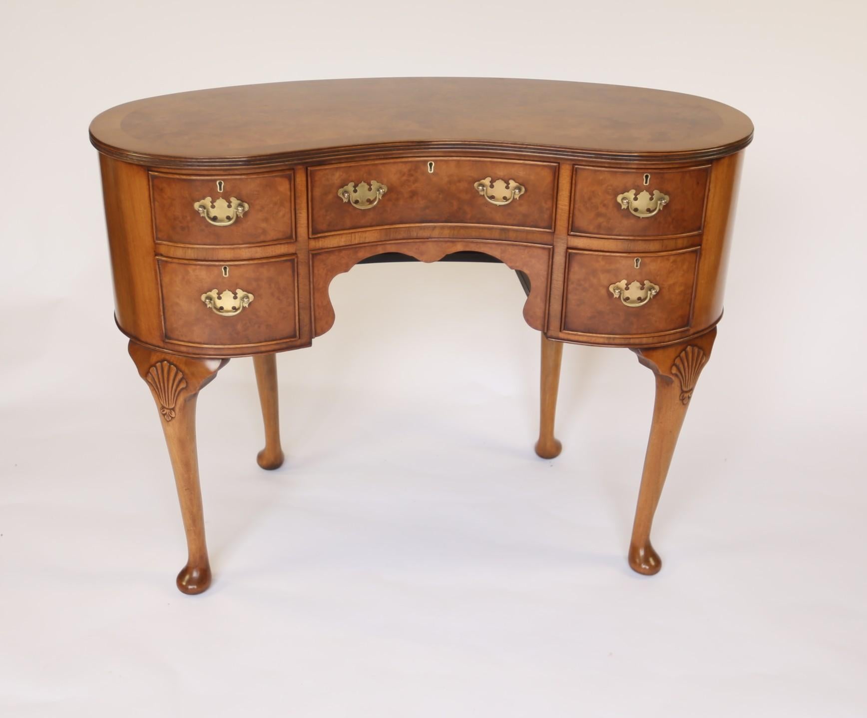 Queen Anne Style Burr Walnut Dressing table with stool circa 1930s
Kidney shaped Burr walnut top with walnut cross banding, 
Burr Walnut Drawer fronts with brass drop handles, 
Sitting on 4 Cabriole shaped legs with shell carving on knees. 
With: