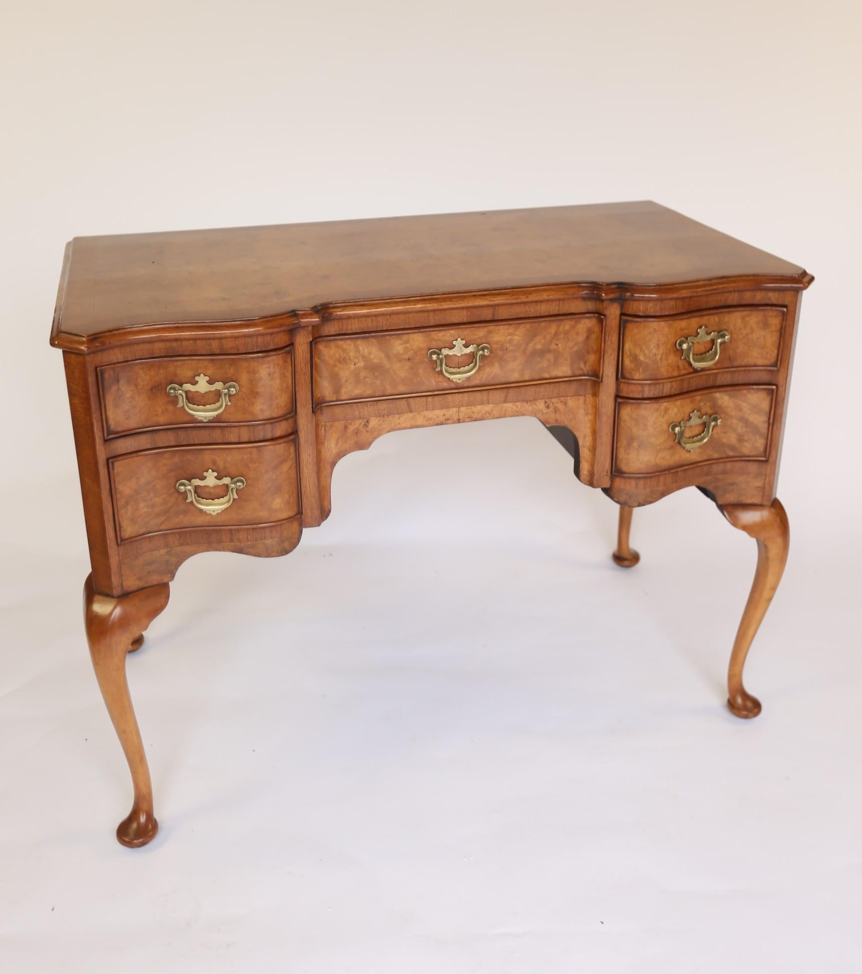 Queen Anne Style Burr Walnut Dressing Table with Stool circa 1930s
Shaped Front
Burr walnut top with walnut cross banding, 
Burr Walnut Drawer Fronts with Brass Handles
Sitting on 4 Cabriole Shaped Legs, 
With:
Walnut Triple mirror, Swing centre