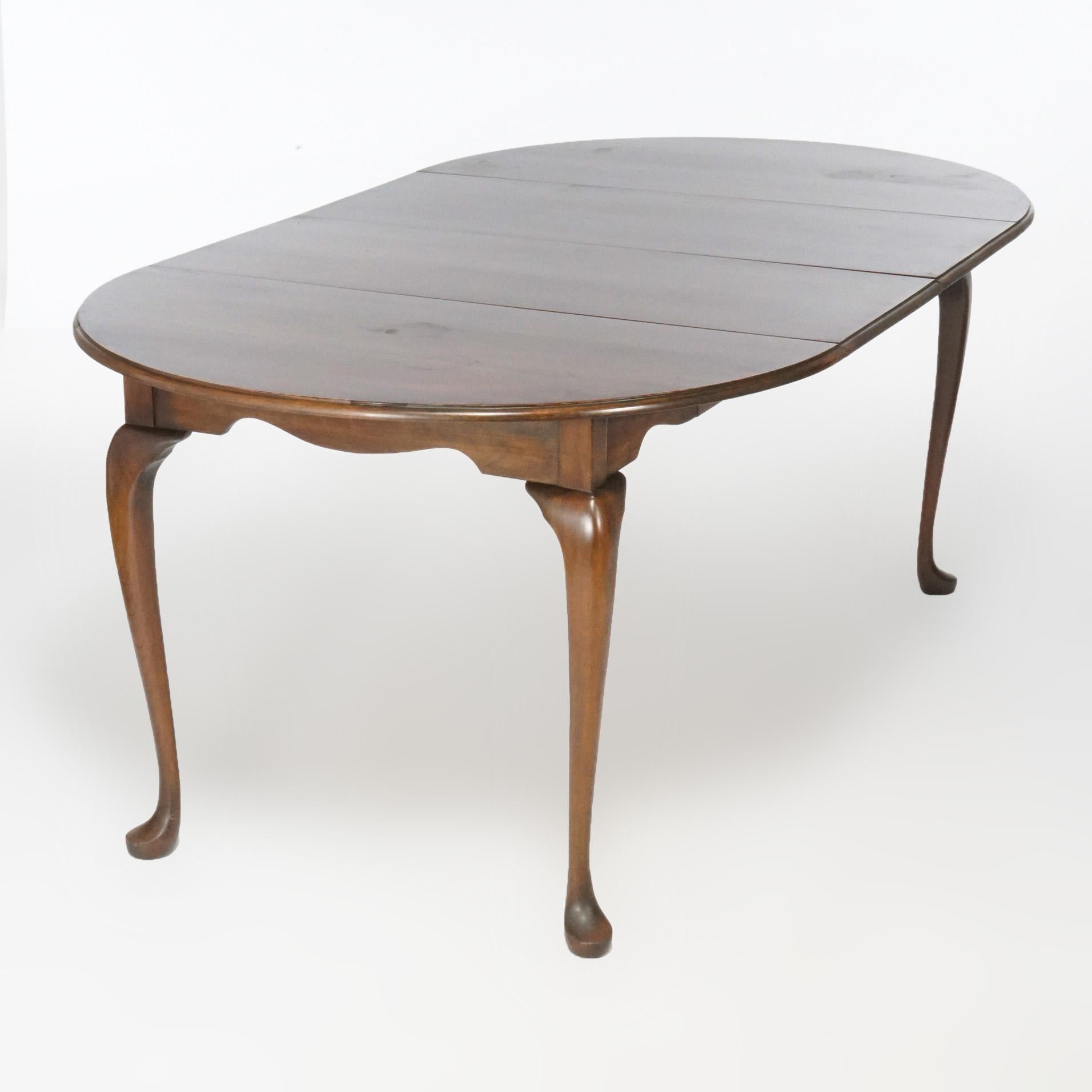 A Queen Anne style breakfast dining table offers cherry construction with circular top extending to accept two leaves and raised on cabriole legs terminating in pad feet, 20th century

Measures- 30''H x 41.75''W x 41.75''D; with single leaf 58'';