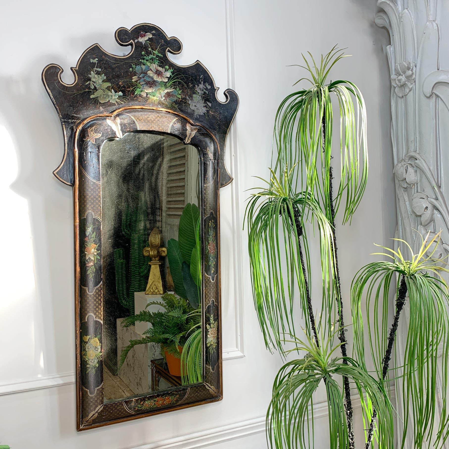 Truly exceptional mirror in the Queen Anne manner, gilt edging and Japanned decorative elements of butterflies and flowers on an ebonised background.

This is an absolutely beautiful mirror and retains its original mercury plate, with some mild