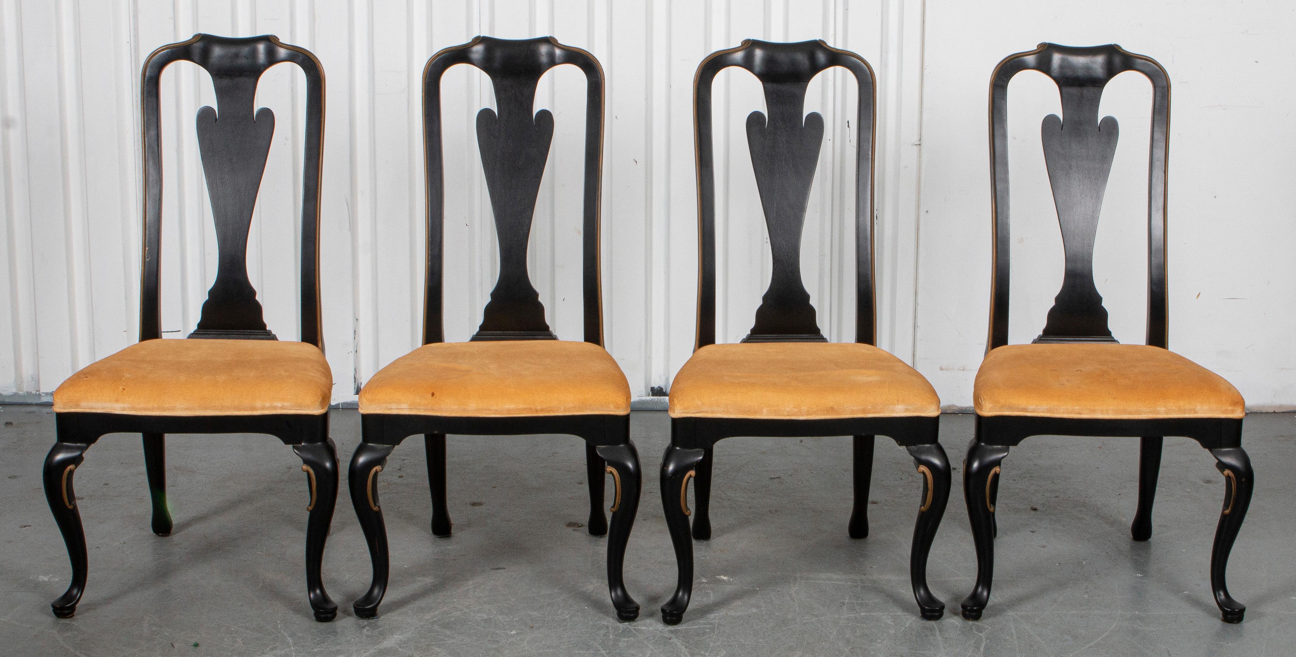 Four Queen Anne style ebonized side chairs with Rococo details and gilt accents around velvet seats, possibly Widdicomb. Measures: 43” H x 22” W x 25” D.