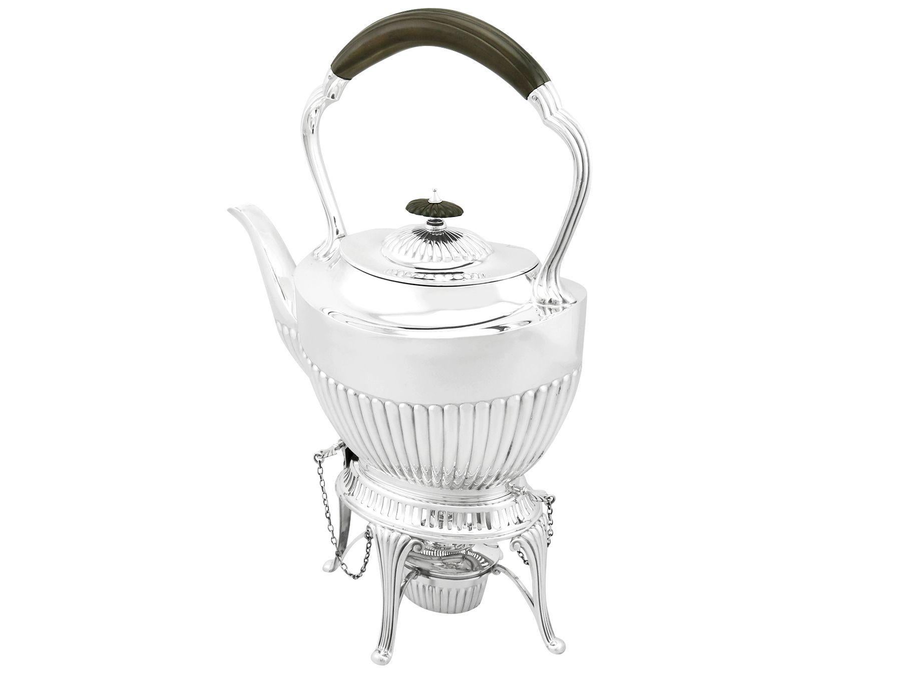 An exceptional, fine and impressive antique Edwardian English sterling silver spirit tea kettle made in the Queen Anne style; an addition to our antique silver teaware collection.

This exceptional antique Edwardian silver spirit kettle, in