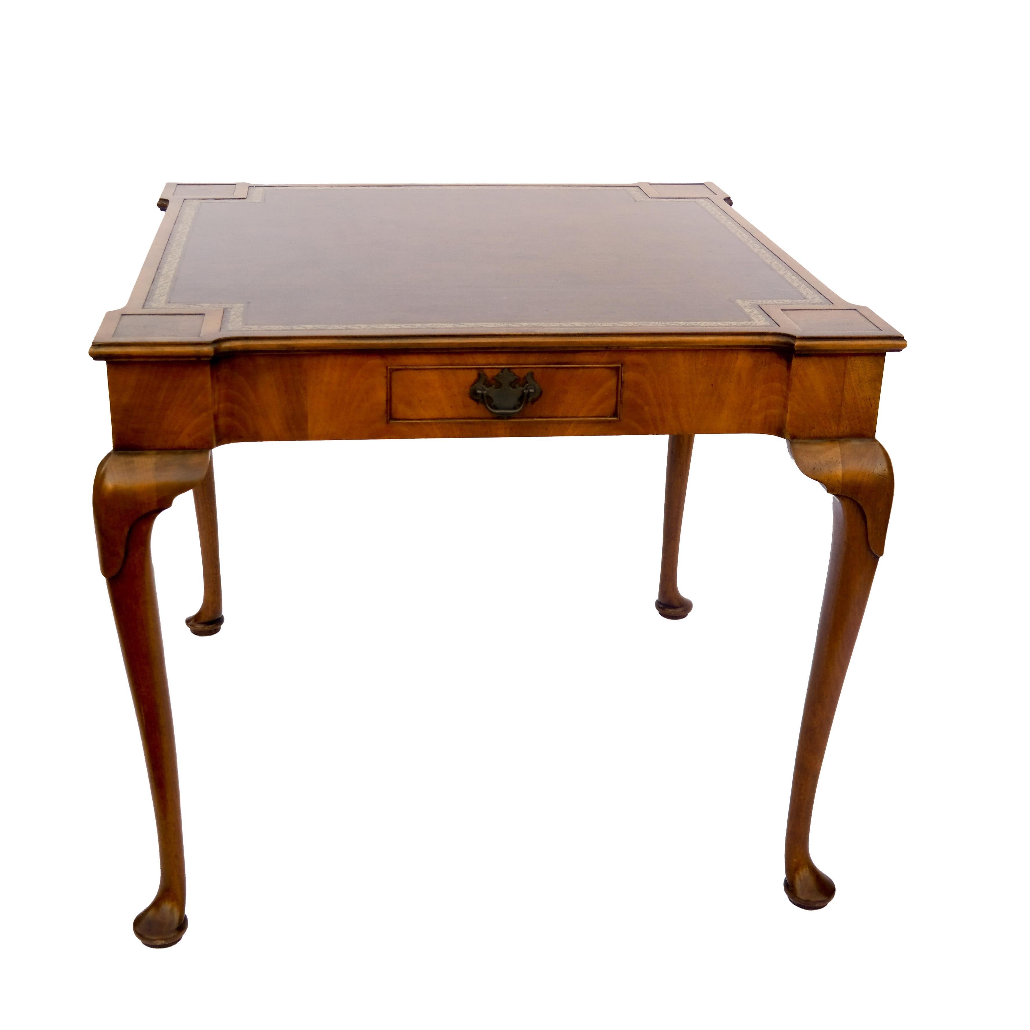 Queen Anne style games table with stenciled leather top, curved legs and pullout / pull-out drawers.