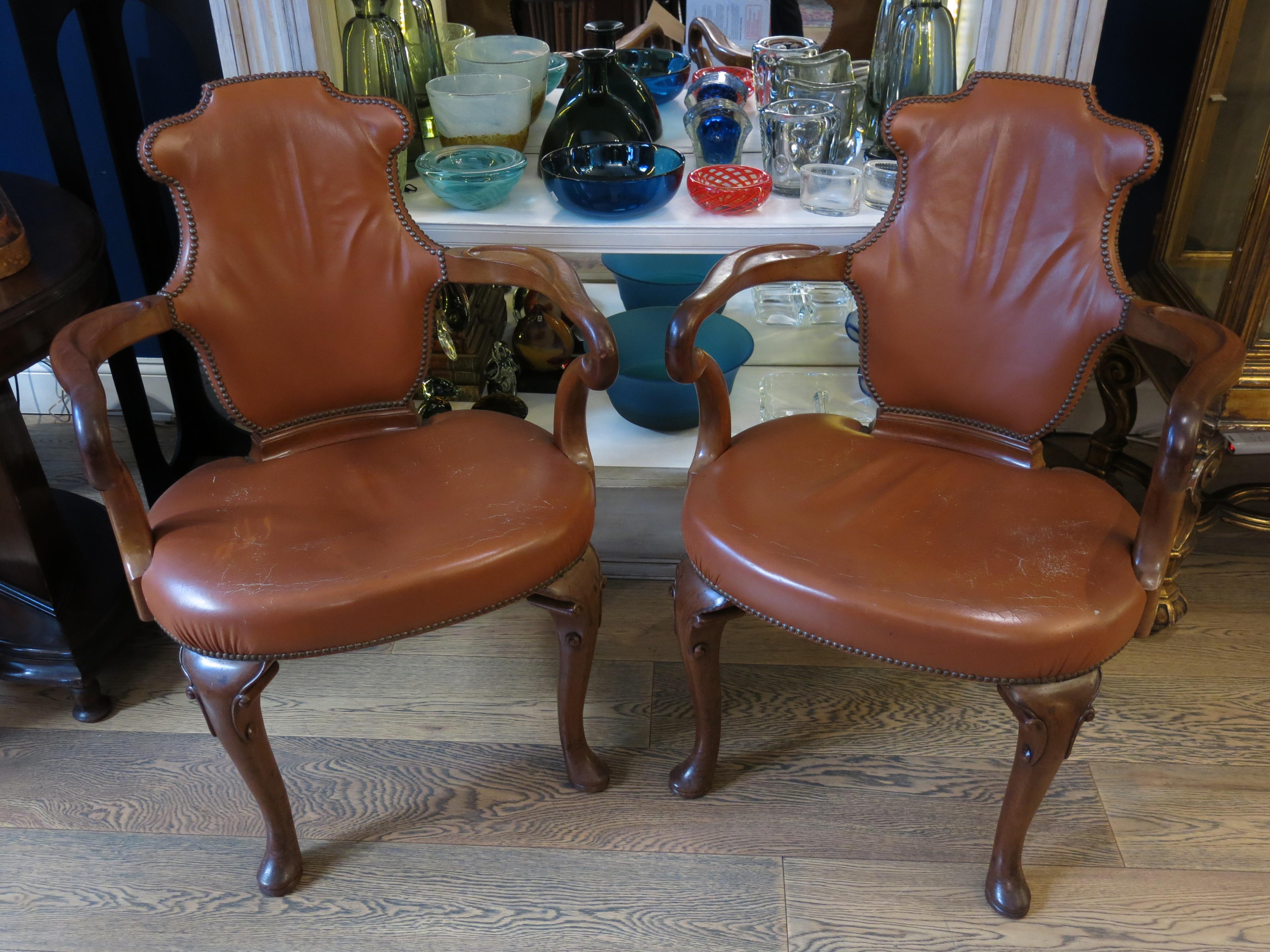 Step into luxurious comfort with this exquisite pair of Queen Anne style leather armchairs. These timeless pieces exude sophistication and elegance, embodying the classic charm of the Queen Anne aesthetic. In very good condition, they boast a rich