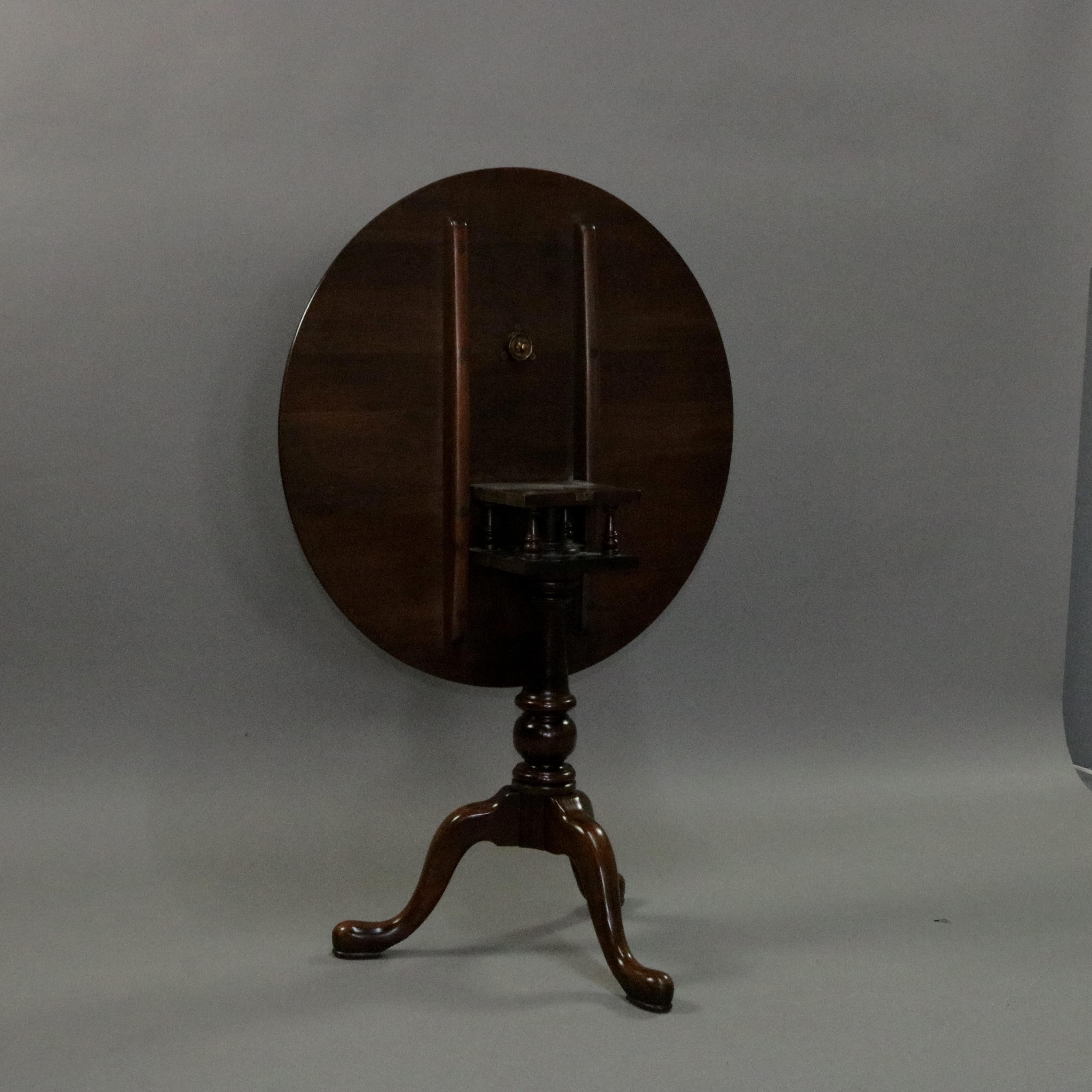 A Queen Anne style tilt-top side table features mahogany construction with round tilt-top having birdcage surmounting turned tripod base seated on cabriole legs with pad feet, 20th century.

***DELIVERY NOTICE – Due to COVID-19 we are employing
