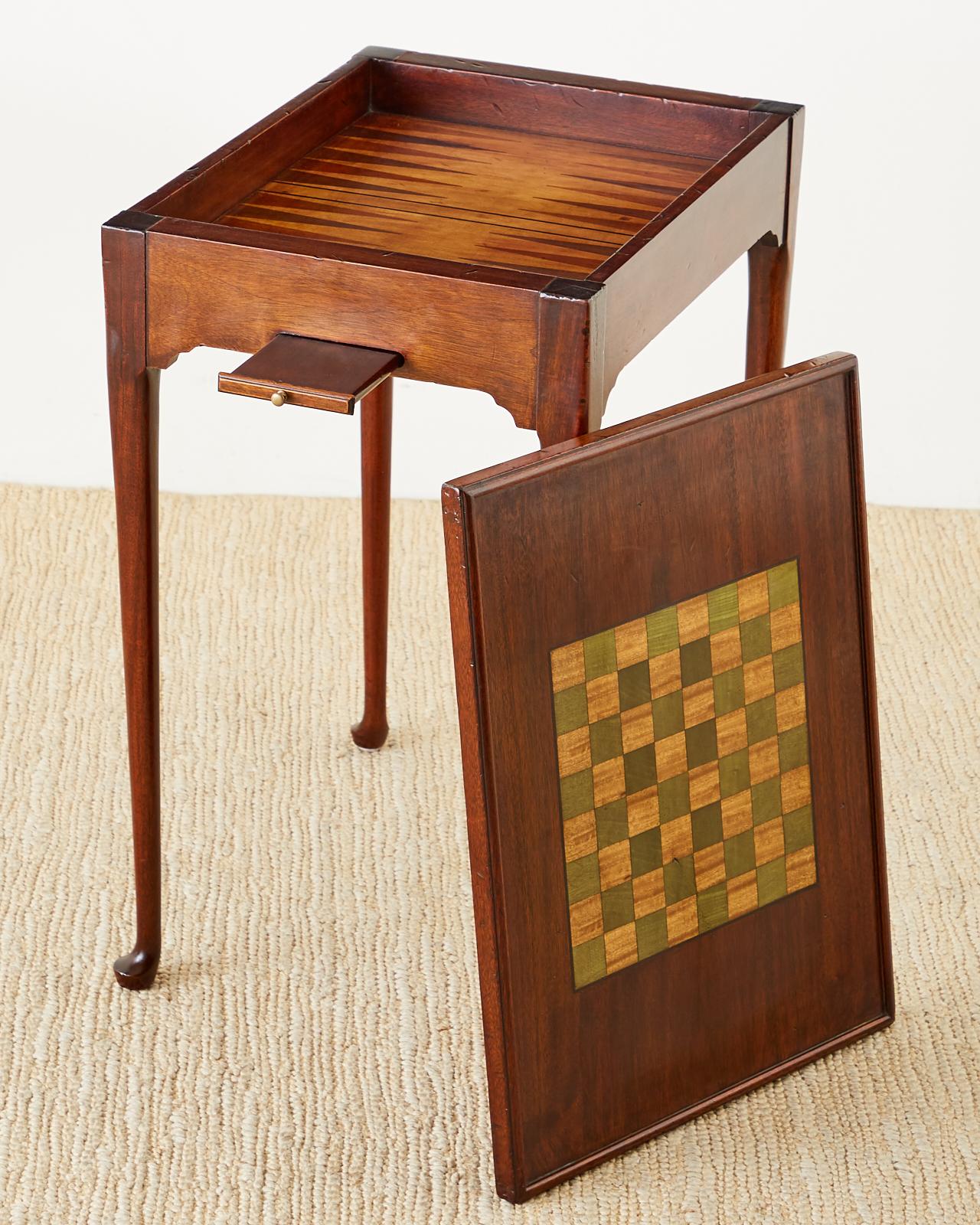 Painstaking reproduction of a 17th century Queen Anne style flip-top game table. Handcrafted from radiant grained mahogany with 1.5 inch thick boards on each end. The table features a flip-top that has a backgammon board on the inside made from