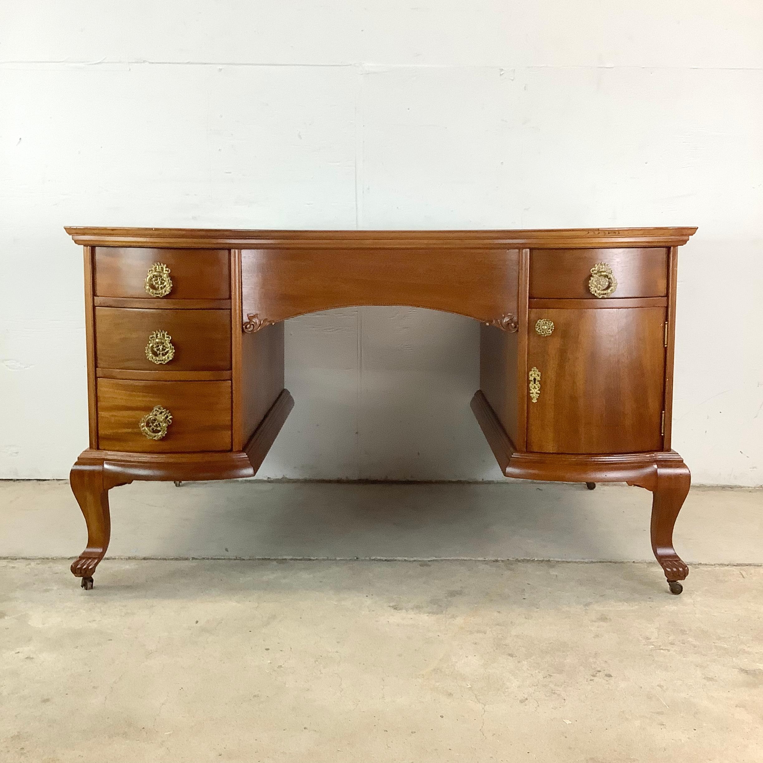 Add timeless charm and high-functioning elegance to your workspace with this vintage Queen Anne Revival mahogany partner desk. Rich in detail and designed for practical use, this desk features a dual-sided configuration with four drawers and two