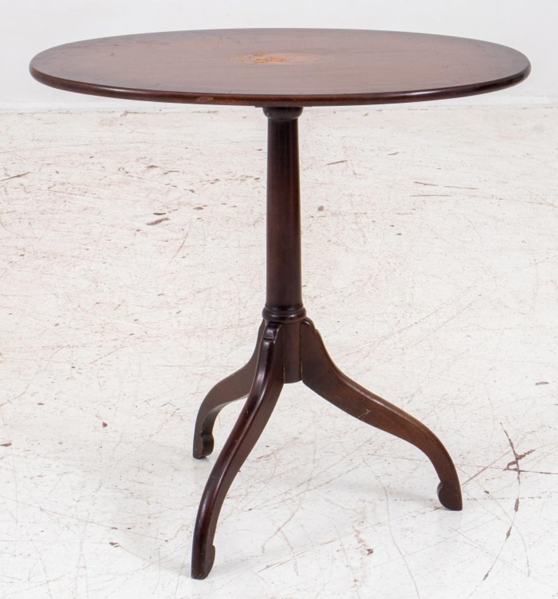 Queen Anne style mahogany tilt-top gueridon or tripod table, top enhanced with coat of arm marquetry motif with eagle.

Dimensions: 25.75