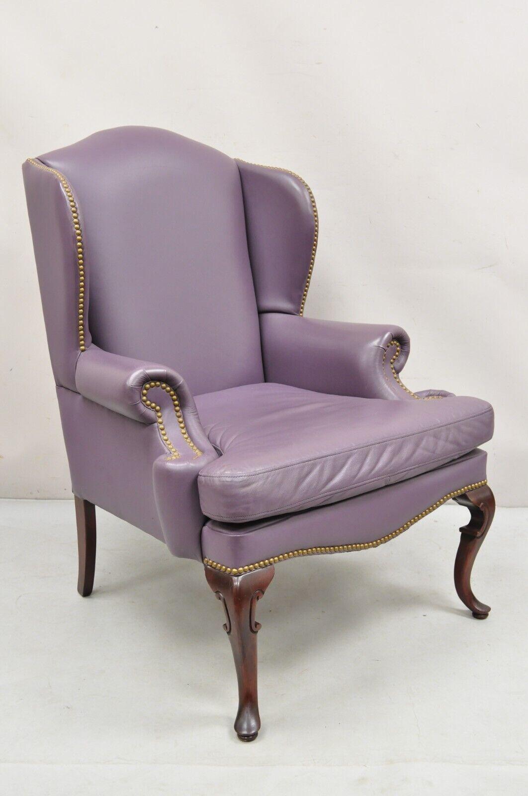 Vintage Queen Anne Style Purple Leather Wingback Chair with Nail Heads and Cherry Legs by Leather Center Inc. Circa  Late 20th Century. Measurements: 43