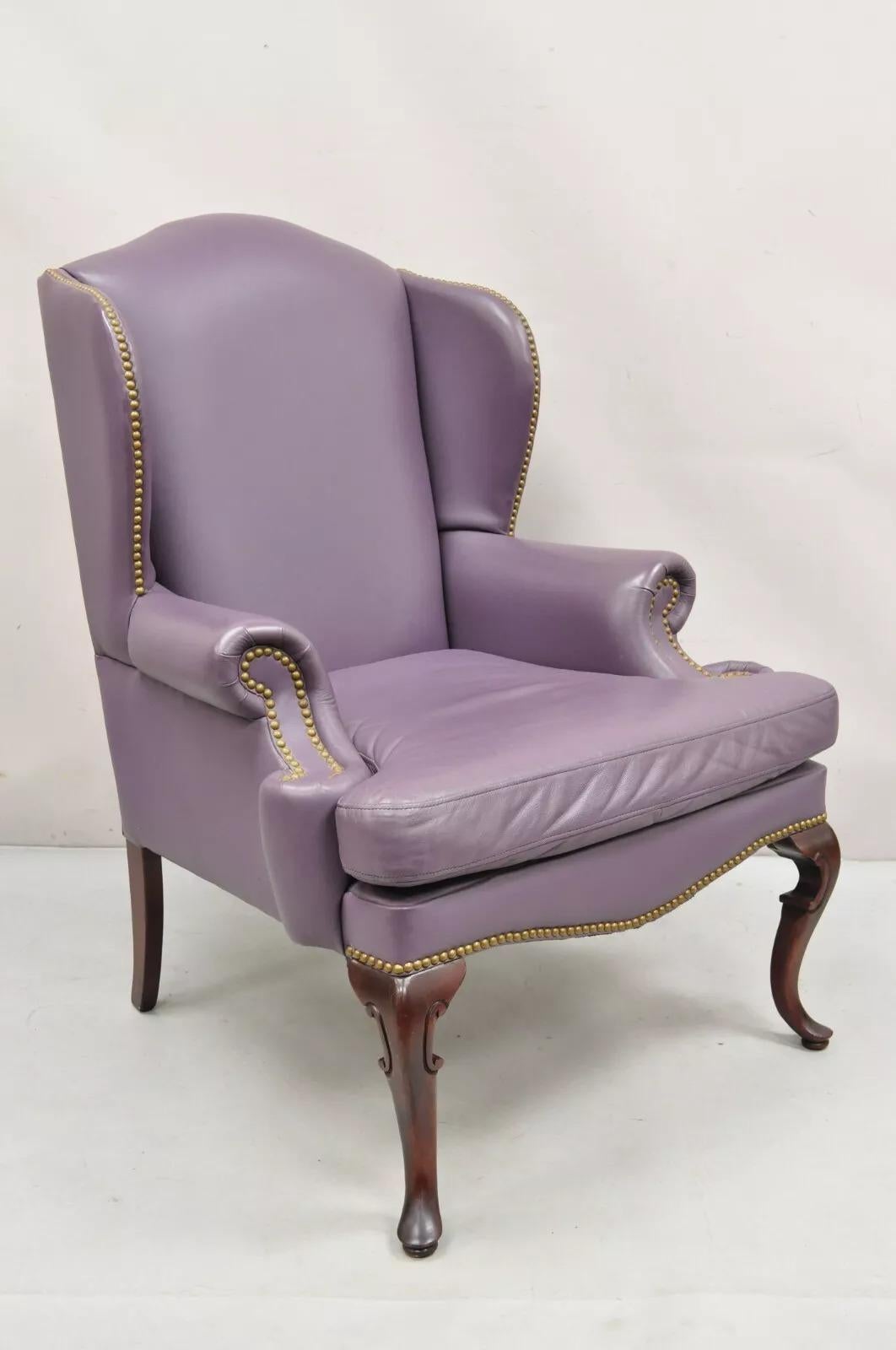 Vintage Queen Anne Style Purple Leather Wingback Chair with Nail Heads and Cherry Legs by Leather Center Inc. Circa Late 20th Century. Measurements: 43