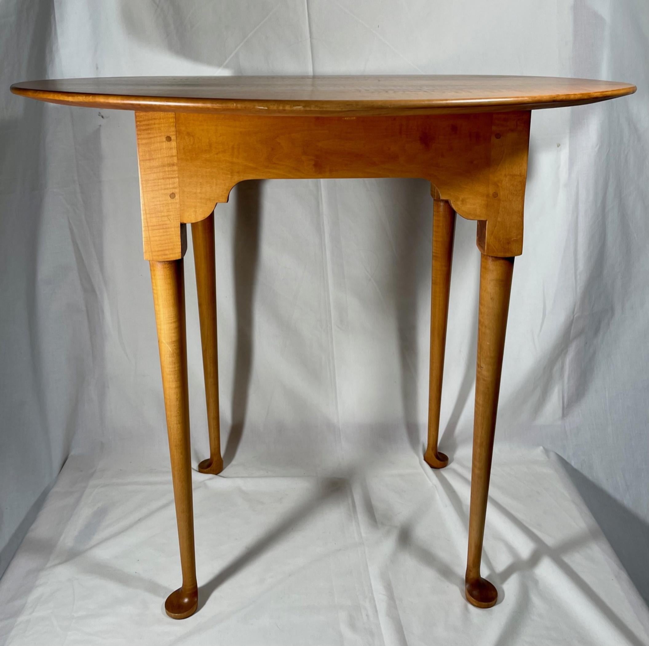 Queen Anne style side table by Eldred Wheeler. 

The oval top side table is made from tiger maple in the American country Queen Anne style of the 18th Century by Eldred Wheeler. This earlier Wheeler creation is beautifully crafted in exacting