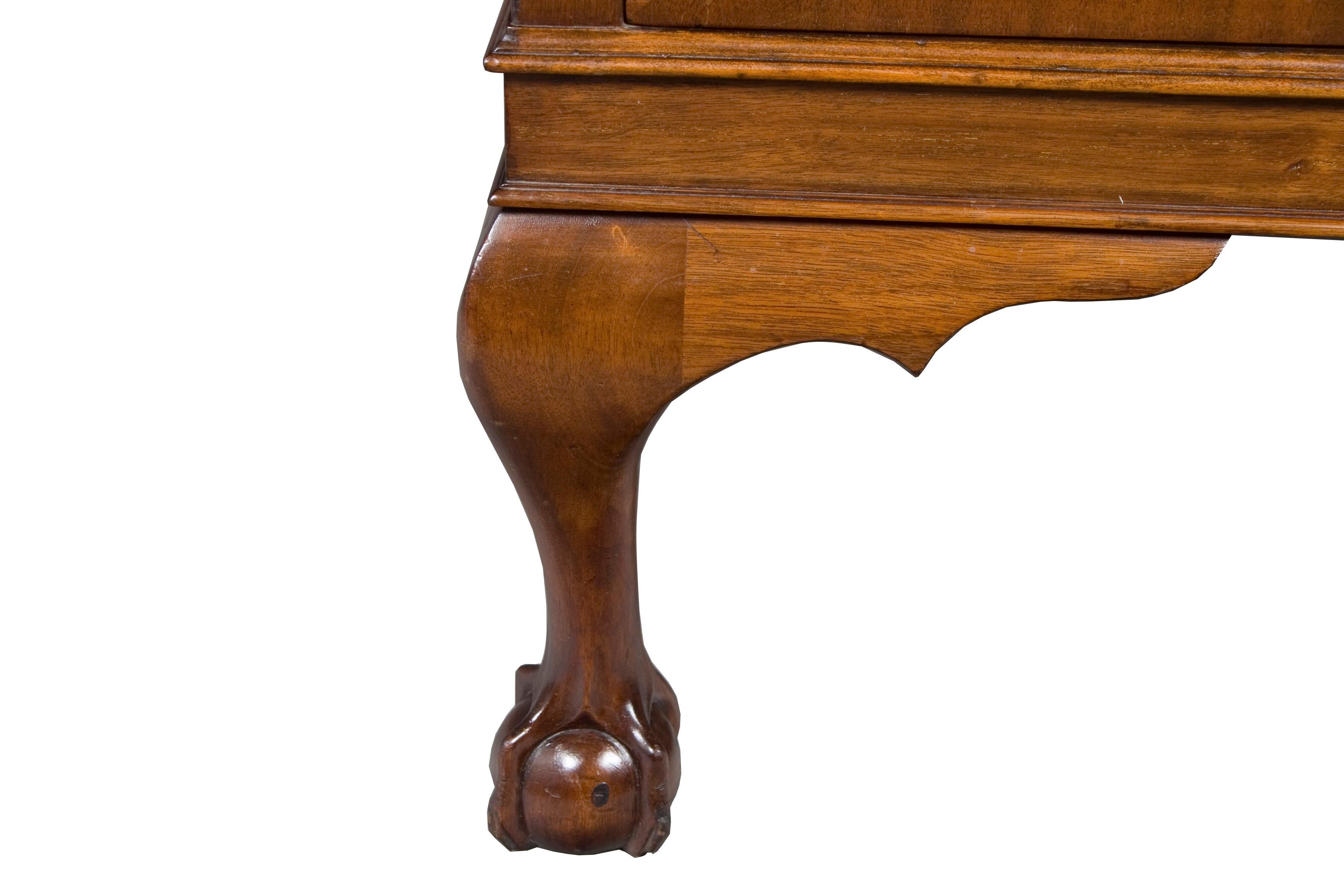 This beautiful sideboard was made in England, circa 1940 of beautiful flame mahogany. The ball and claw front legs and rope twist carved molding around the top and splash give it a Queen Anne style.
This sideboard has lots of storage space! The