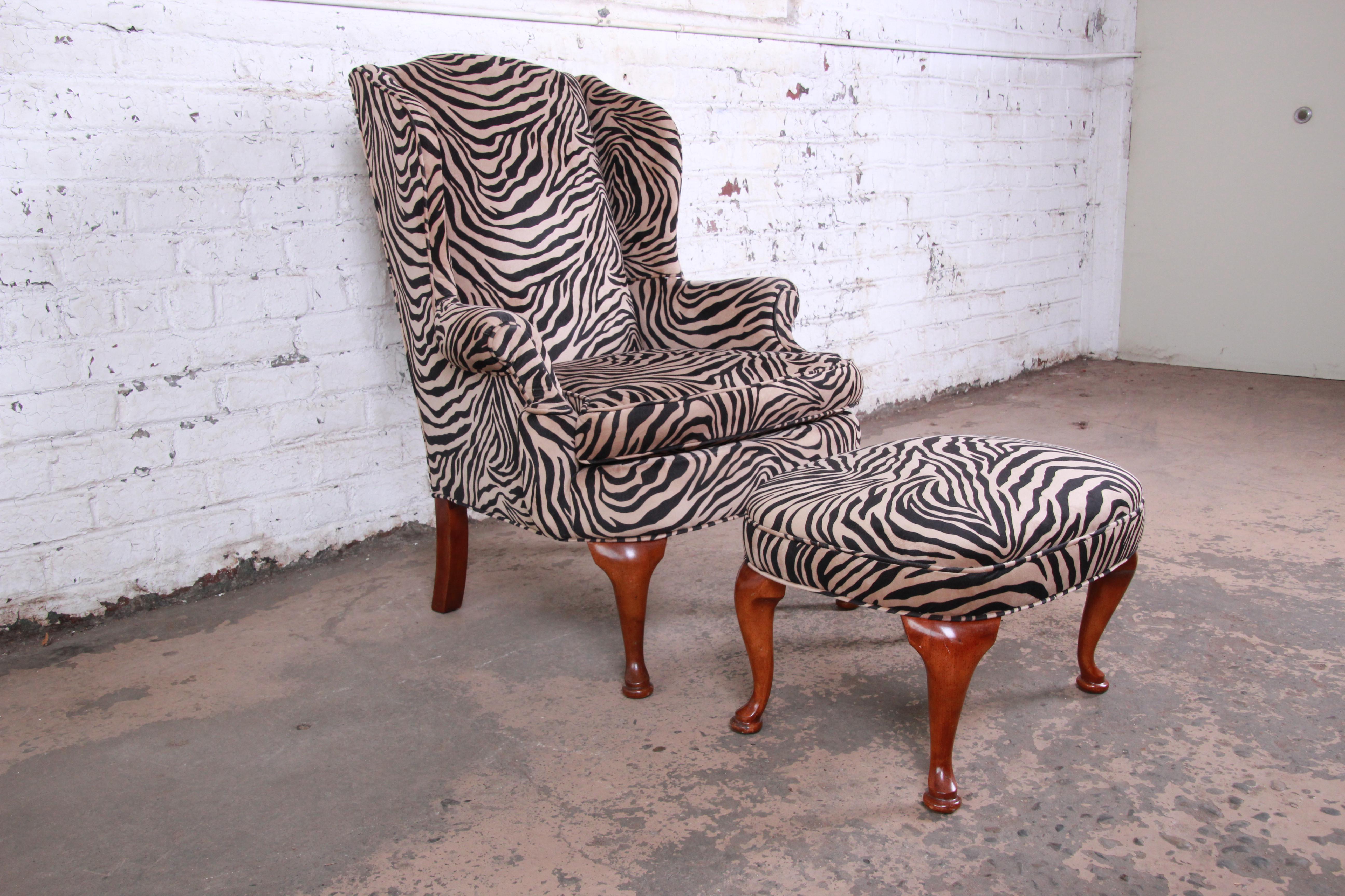 A gorgeous vintage Queen Anne style wingback lounge chair and ottoman. The set features beautiful zebra print upholstery and solid walnut legs. A great mix of modern and traditional styles. The set is clean, very comfortable, and ready for immediate
