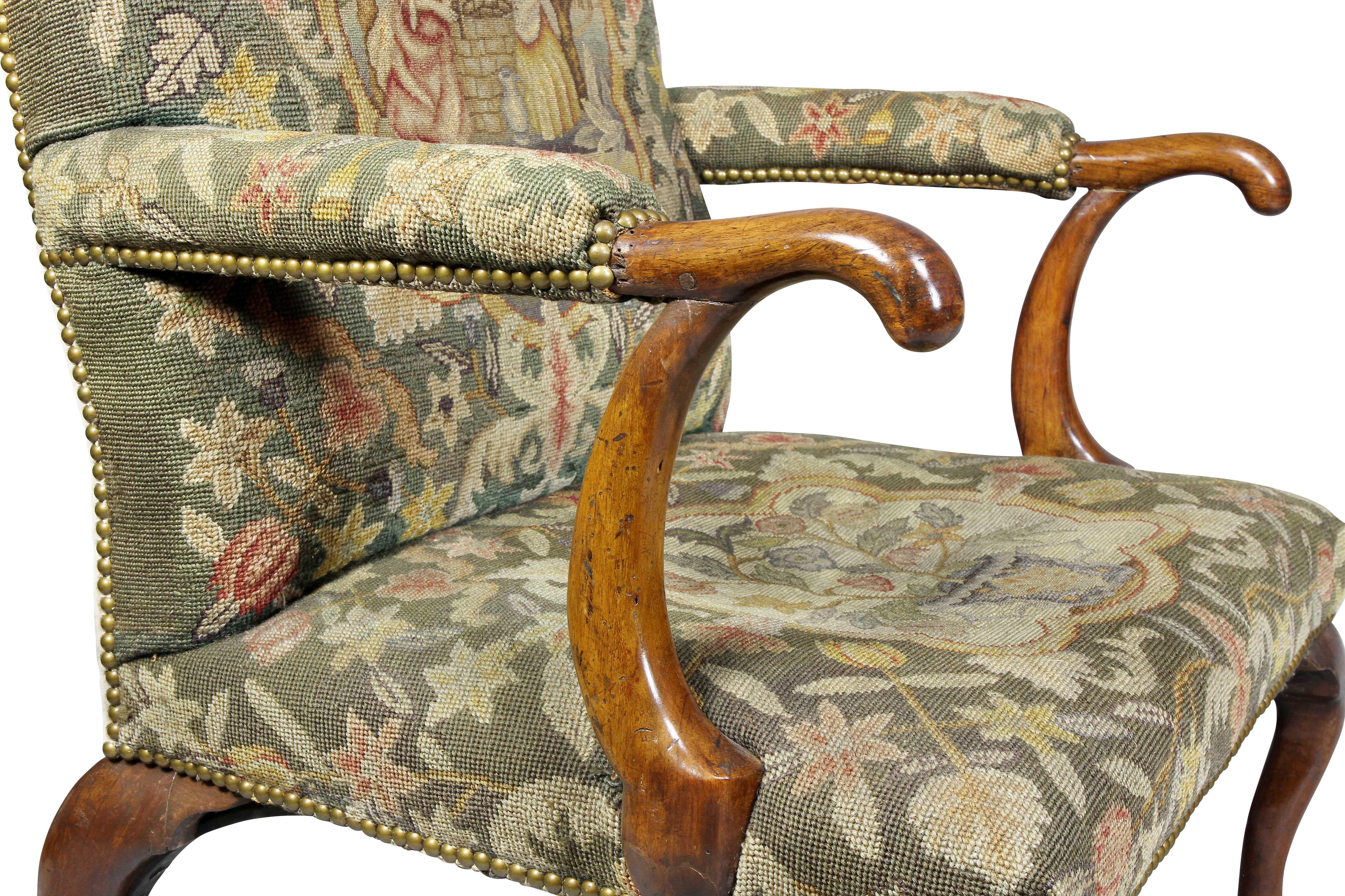 Rectangular back and seat decorated in needlepoint with the back depicting a couple by a well and the seat a basket of flowers, of generous scale, raised on cabriole legs ending on pad feet, the rear legs with an elegant sweep. Seat frame rails