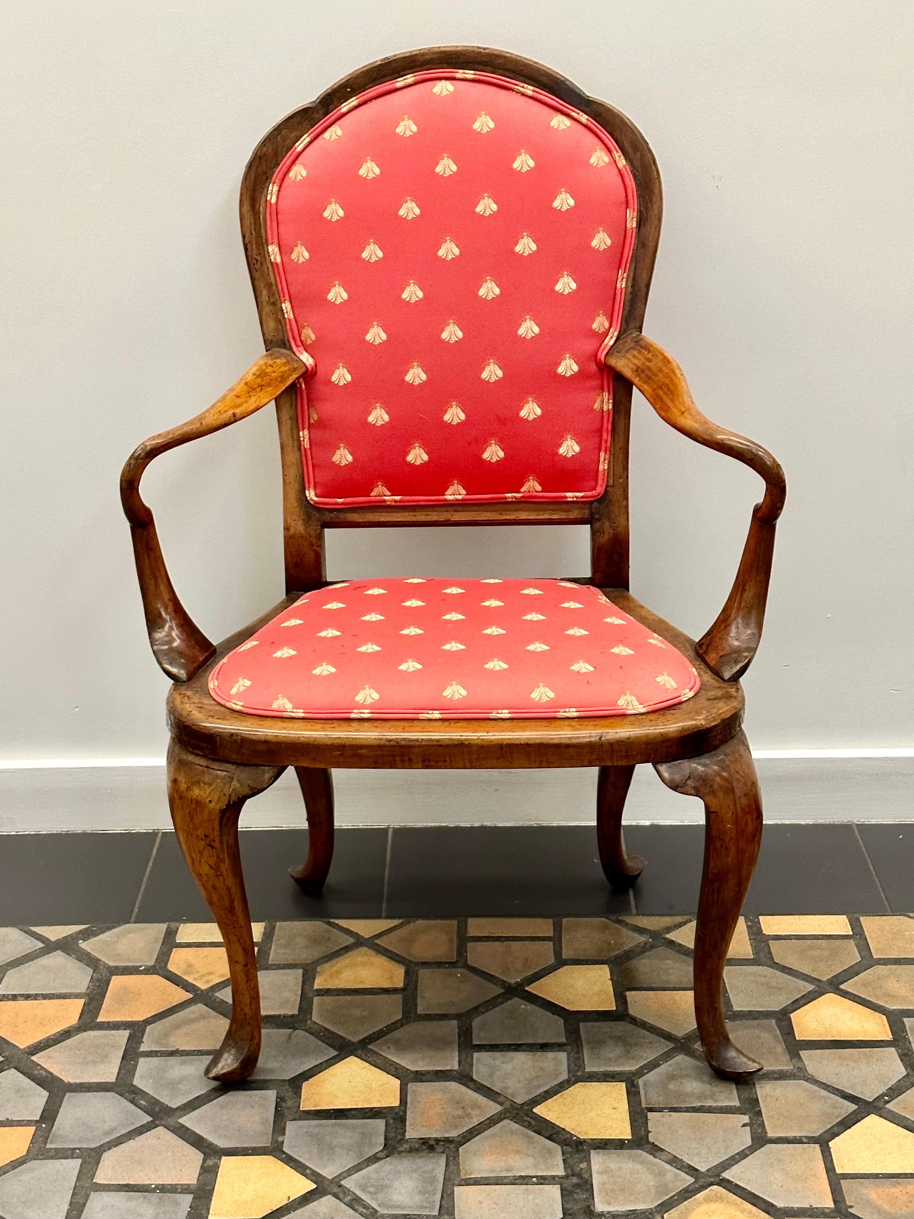 Queen Anne chair made of walnut with upholstered seat.