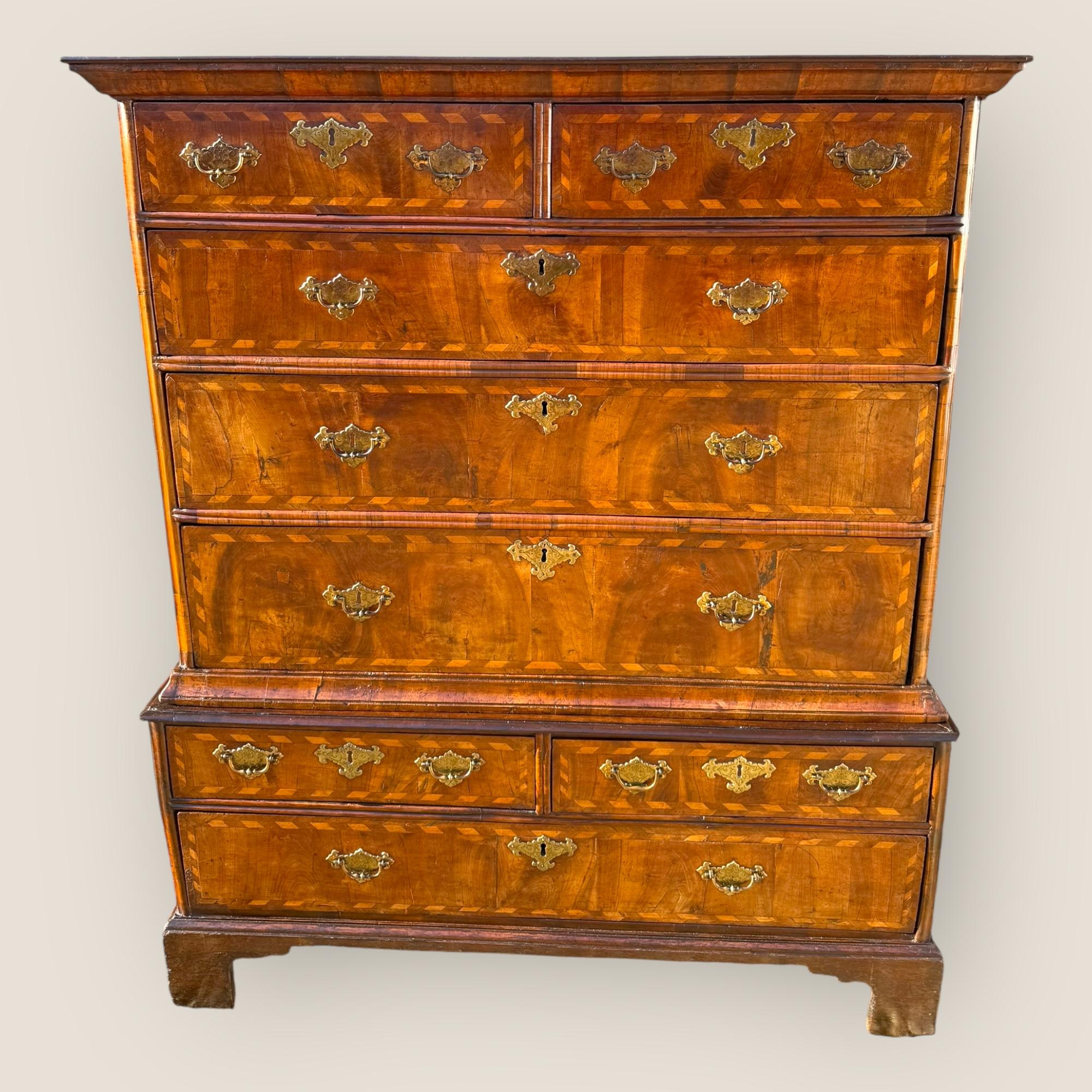 Here we have a Queen Anne, Circa 1710 (315 Years old), Walnut Chest of Drawers. This character piece features a standout herringbone inlay on every drawer and has original brass handles and key inscriptions on all drawers each with engraved