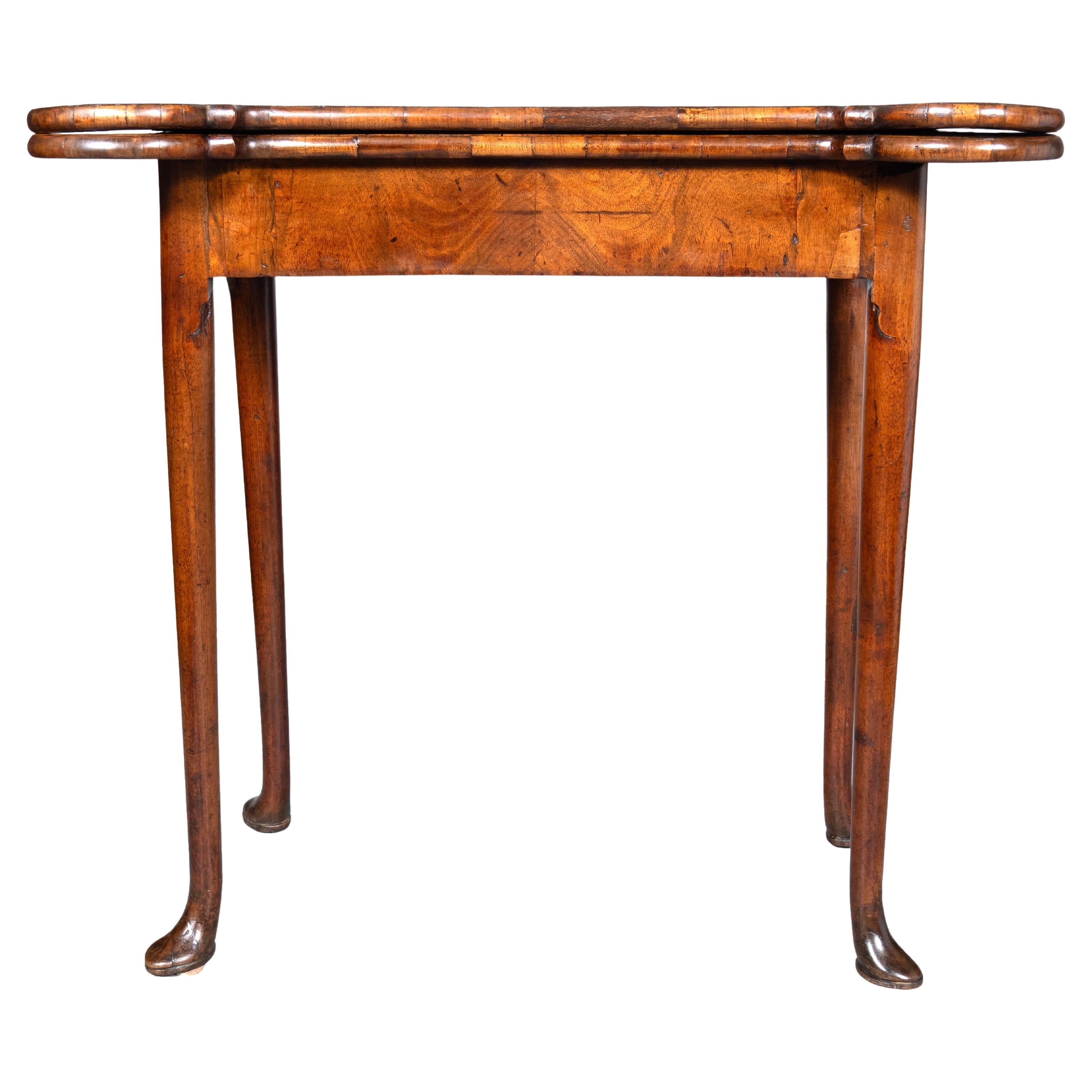 With concertina action and a shaped rectangular top opening to a green baize lined playing surface. Tapered circular legs with pad feet.