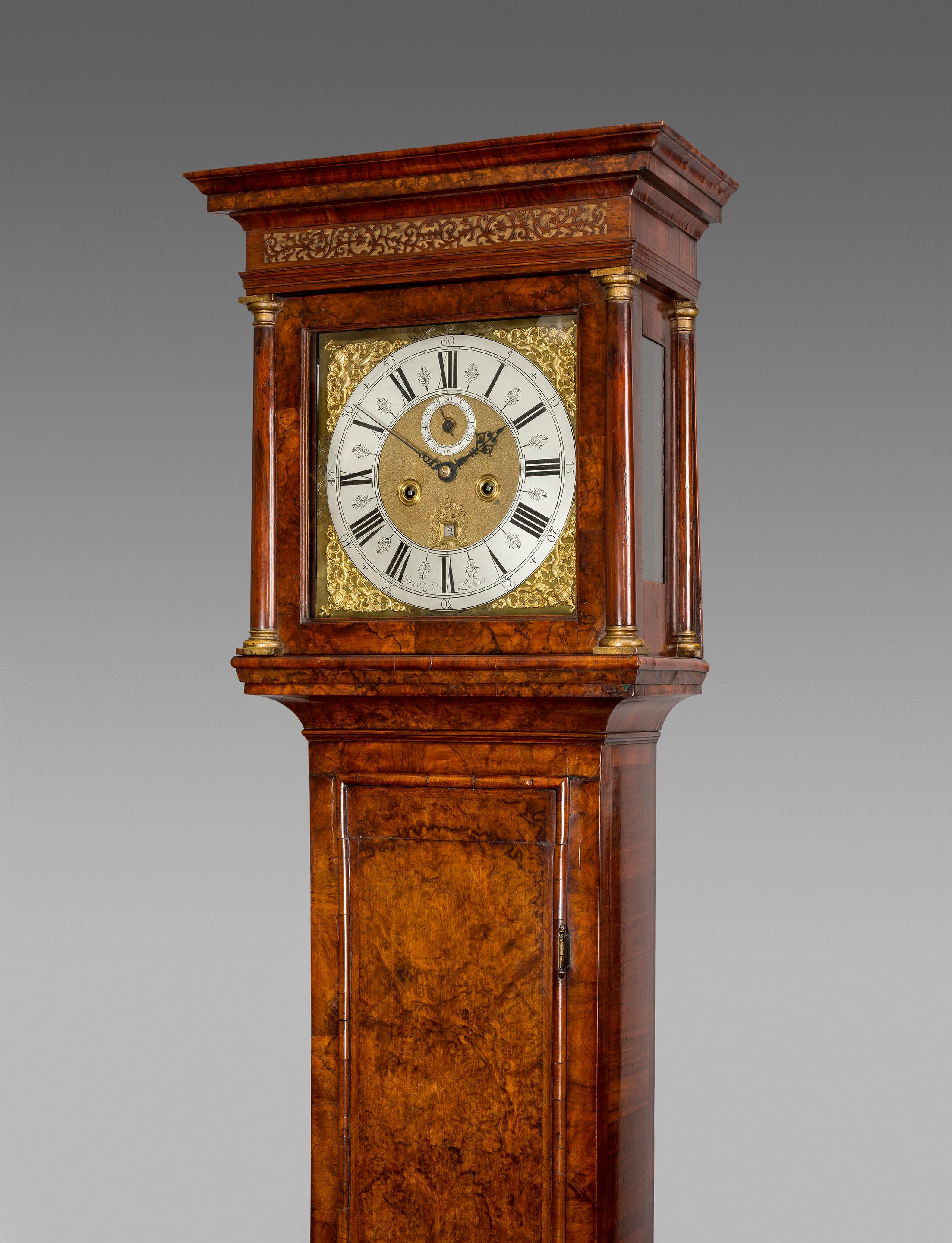 A fine Queen Anne period, early 18th century walnut hour-striking longcase clock by this well-known London clockmaker.

The molded case is veneered with beautifully figured walnut, the herringbone cross-banded rectangular trunk door has raised