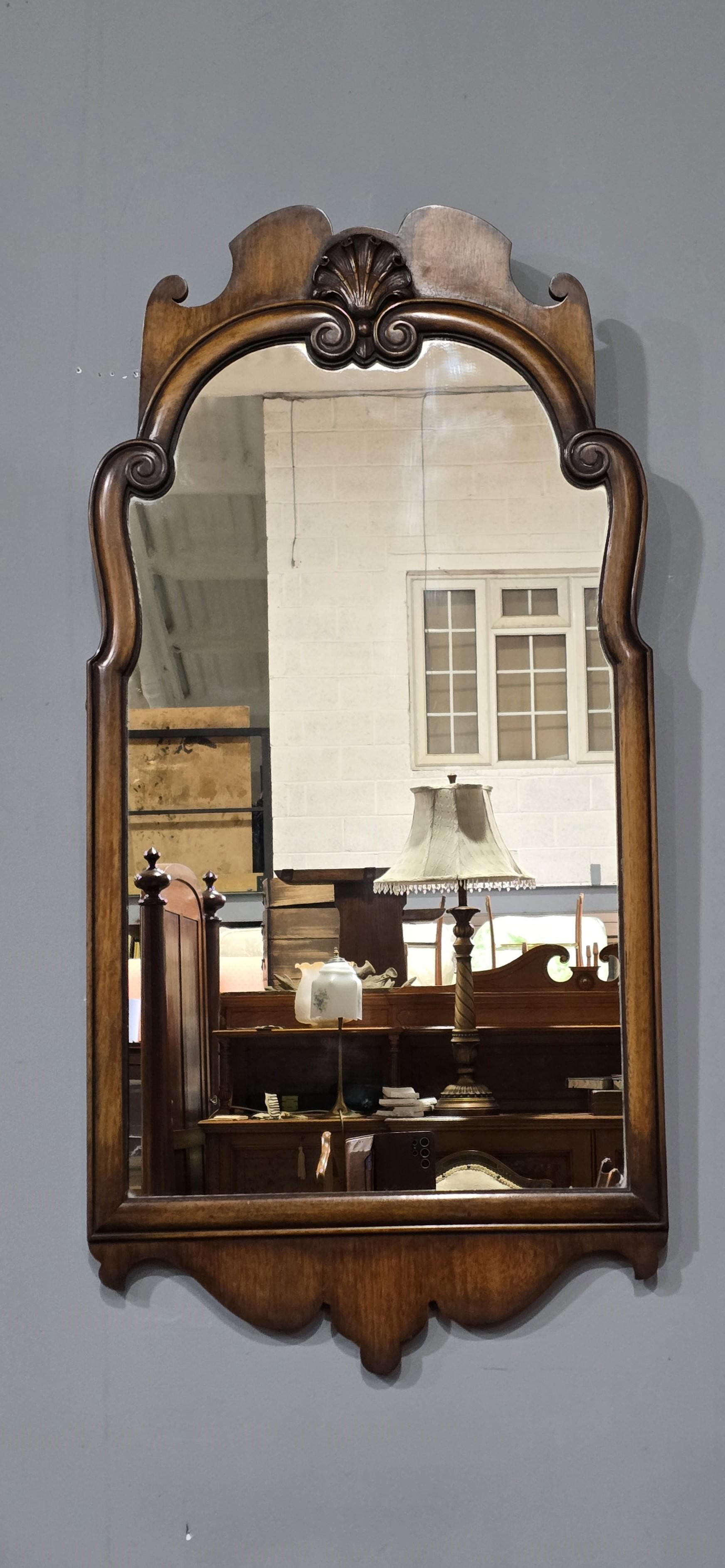 A good cutwork framed Queen Anne walnut wall mirror, scrolled  top with central motif, in excellent overall condition.

40