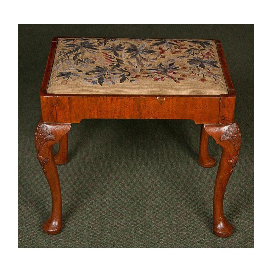 An English walnut, 18th century stool with a slip seat needlepoint cushion, wonderfully shell carved cabriole legs on pad feet.

        