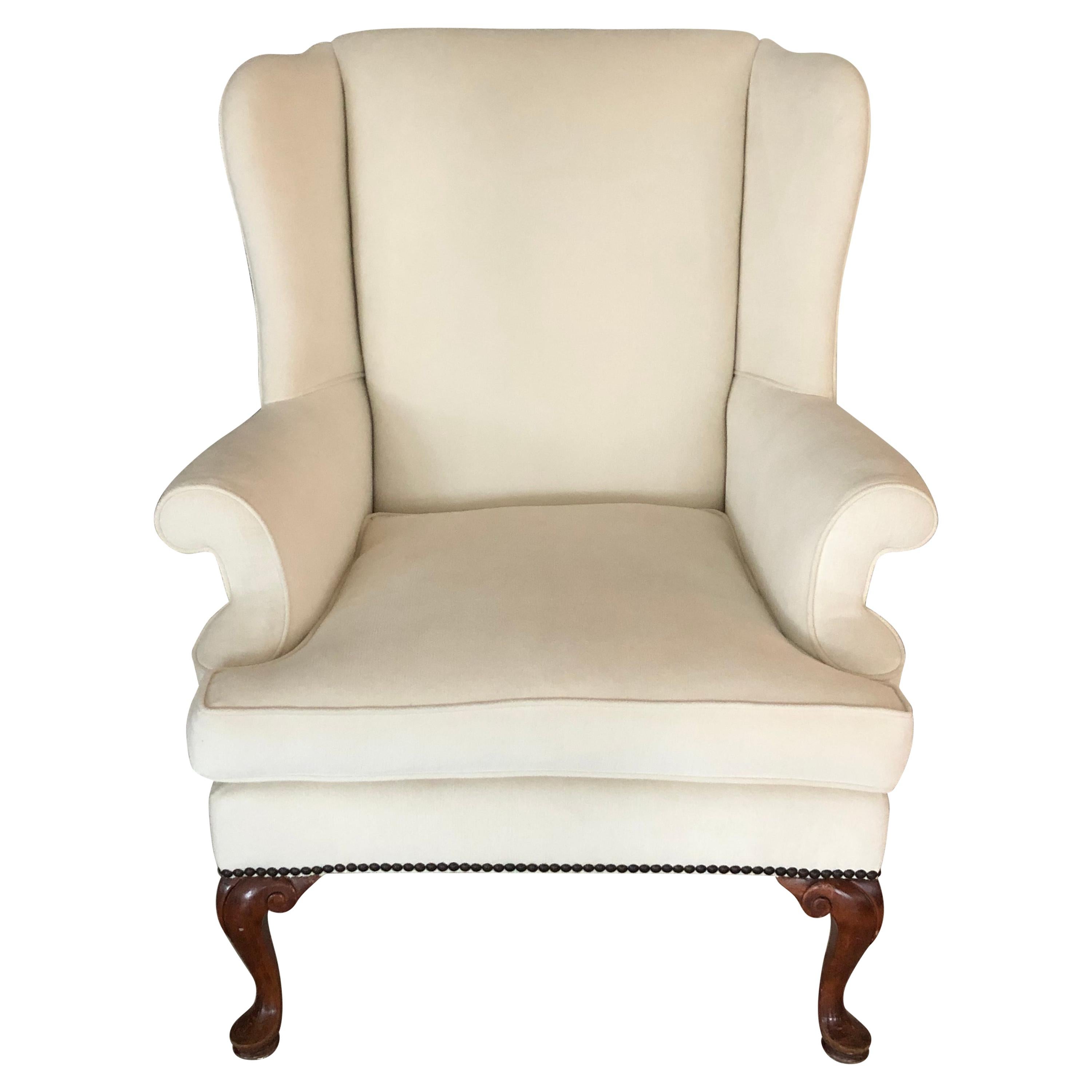 Beautiful Queen Anne wingback chair in off-white fabric. Midcentury, England, circa 1950s.