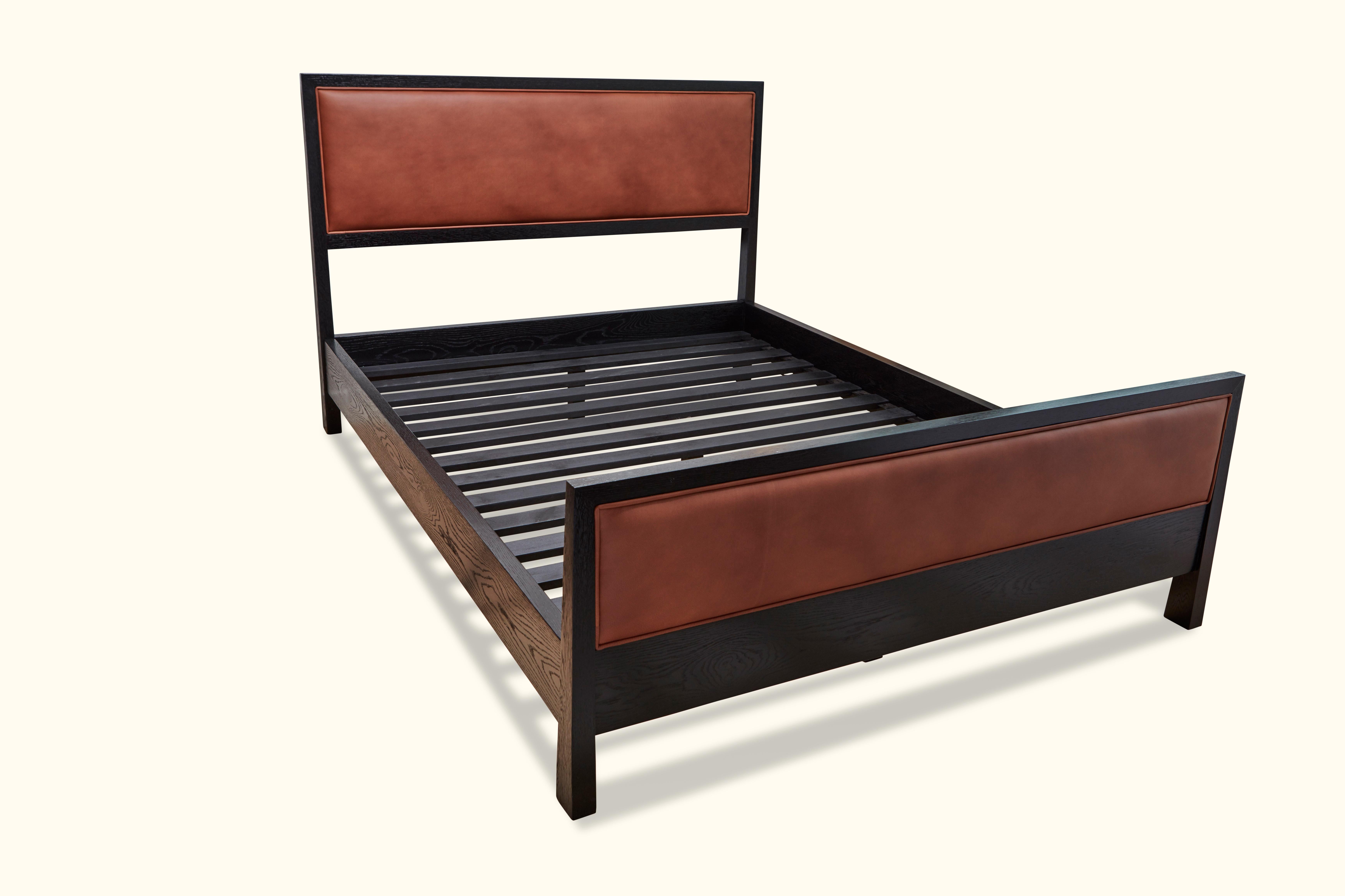 The Auden bed is a solid wood framed bed that can be made in either American walnut or white oak. The piece features an upholstered headboard and footboard. Slats are provided. Shown here in cognac leather and in ebonized oak. Queen size. 

The