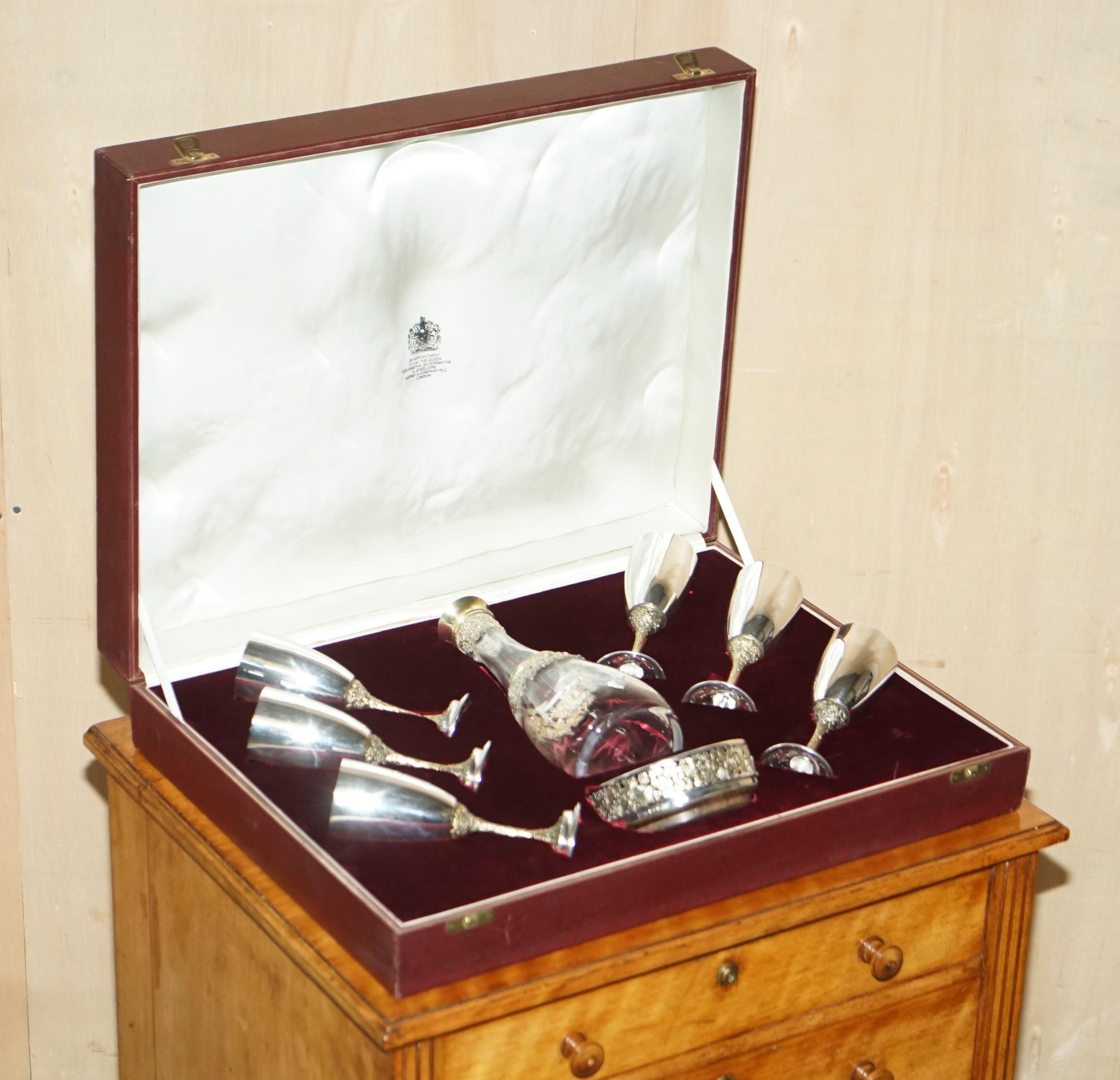 We are delighted to offer for sale this extremely rare and highly collectable, finest quality, HM Stamped, Asprey London solid Sterling Silver & Gold Gilt 1983 Decanter set complete with base and six goblets, by Appointment to Her Majesty Queen
