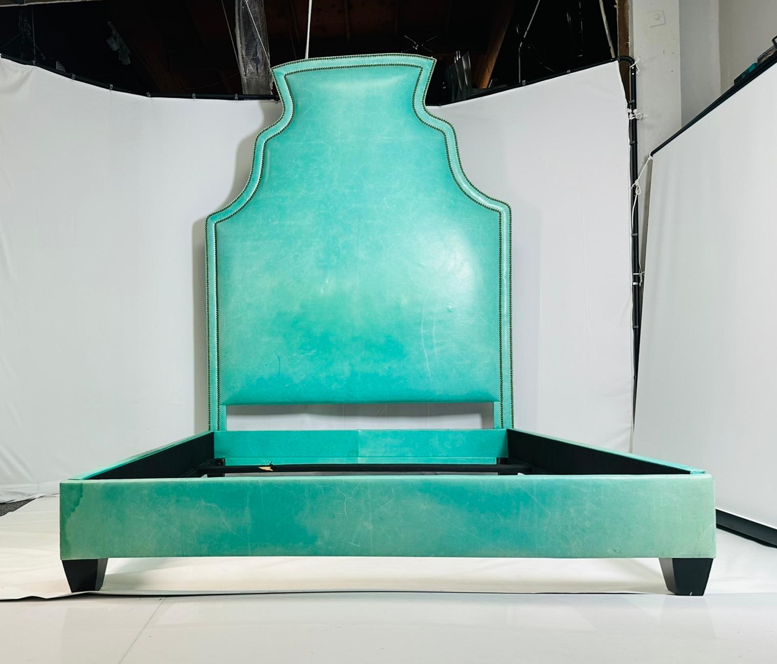 Queen size bed fully upholstered in aqua green leather and nail-head detail.

Measurements:
93 inches high x 67 inches wide x 88 inches deep x 12.50 inches rail height.
Mattress space: 64 inches wide x 83 inches deep.