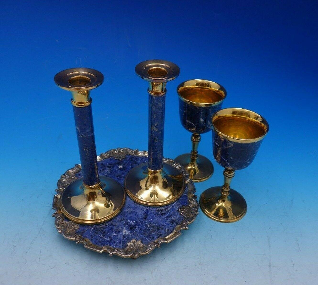 Garrard and Co.

Superb Garrard and Co. sterling silver five piece console set. This set includes:

2 - Wine glass: Gilt with sodalite (blue stone) in original box. Measures: 2