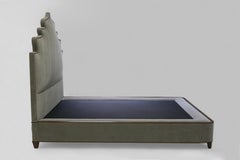 Queensize Bed with Carved Headboard with Nailheads and Covered Base on Wood Legs