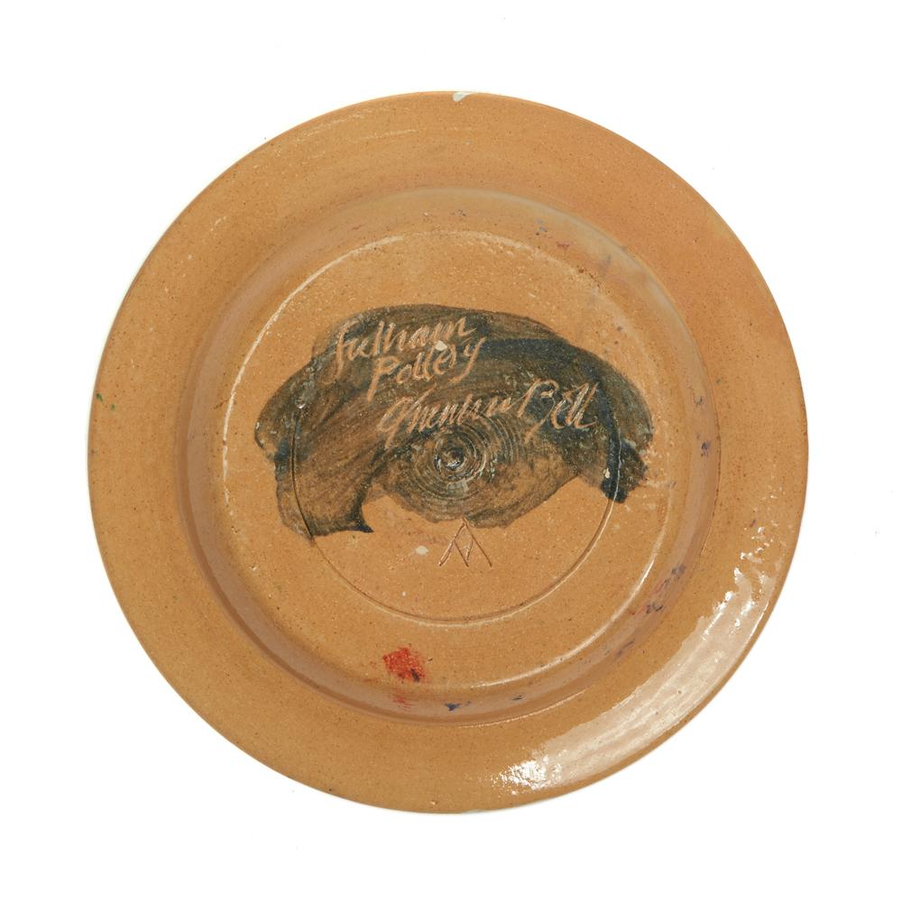 A Fulham Pottery shallow bowl form plate by Quentin Bell and Vicky Walton hand painted with a central radiating flame design in bright yellow and red on a mottled blue ground with cloud like designs in white and grey painted around the rim. The