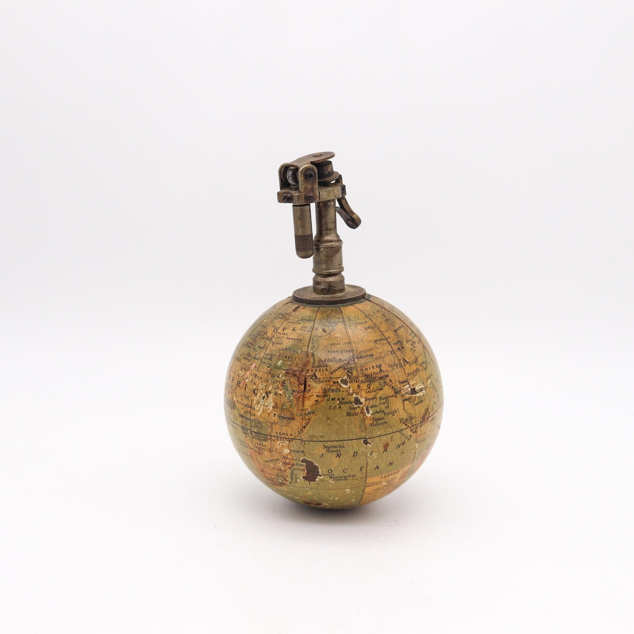 A petrol desk-lighter designed by Quercia.

This novelty item combines a miniature terrestrial globe with a cigarette desk petrol-lighter. The brass lighter apparatus was crafted by the Quercia company and is the model Eclair-730 with a mappemonde.