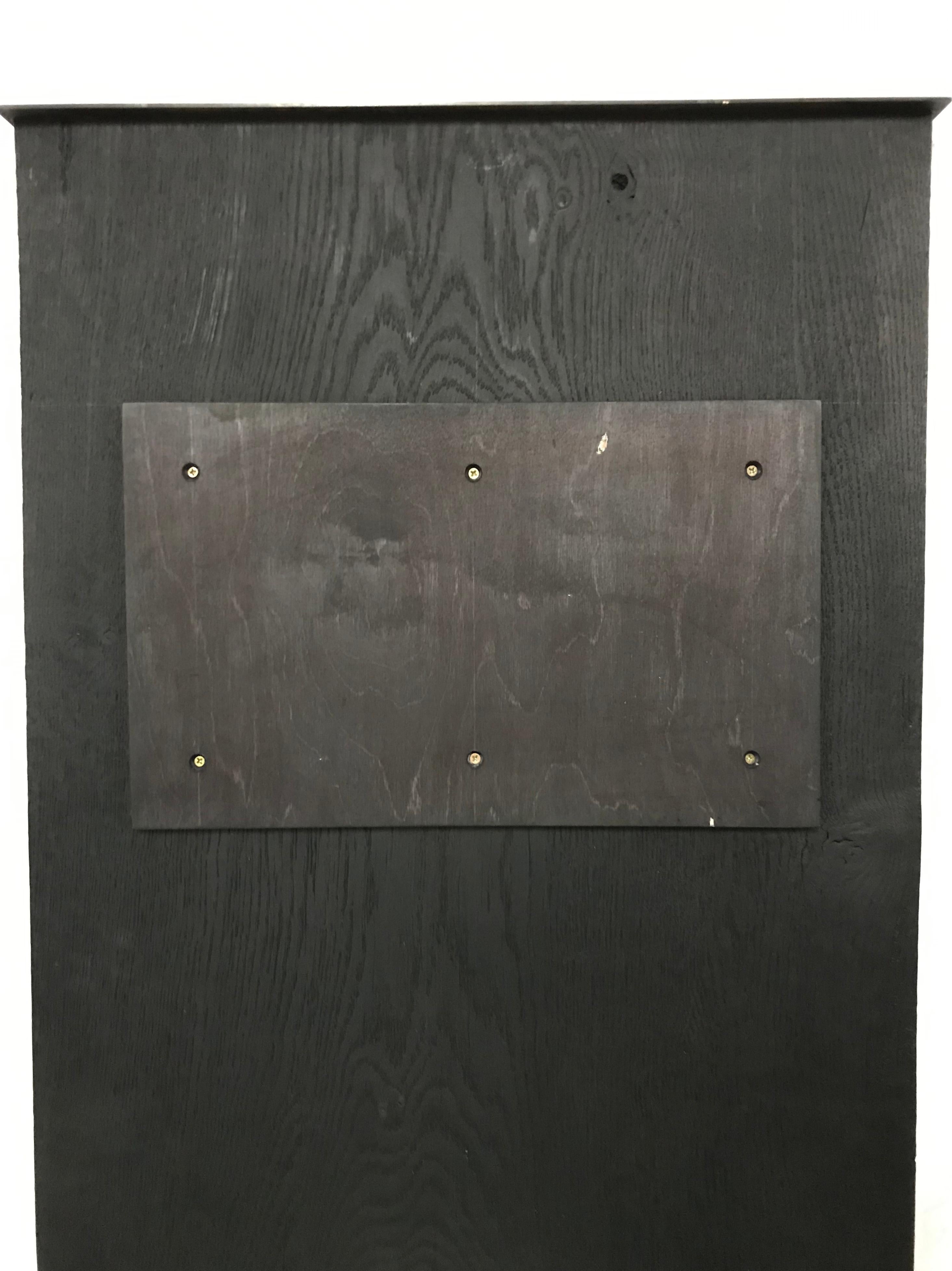 A wall-mounted triptych of oak board with burnt gesso moons, with simple split batten hanging system to the reverse (illustrated). 

To wall mount each separate back plate provided is fixed to the wall by screws through multiple pre-drilled holes,