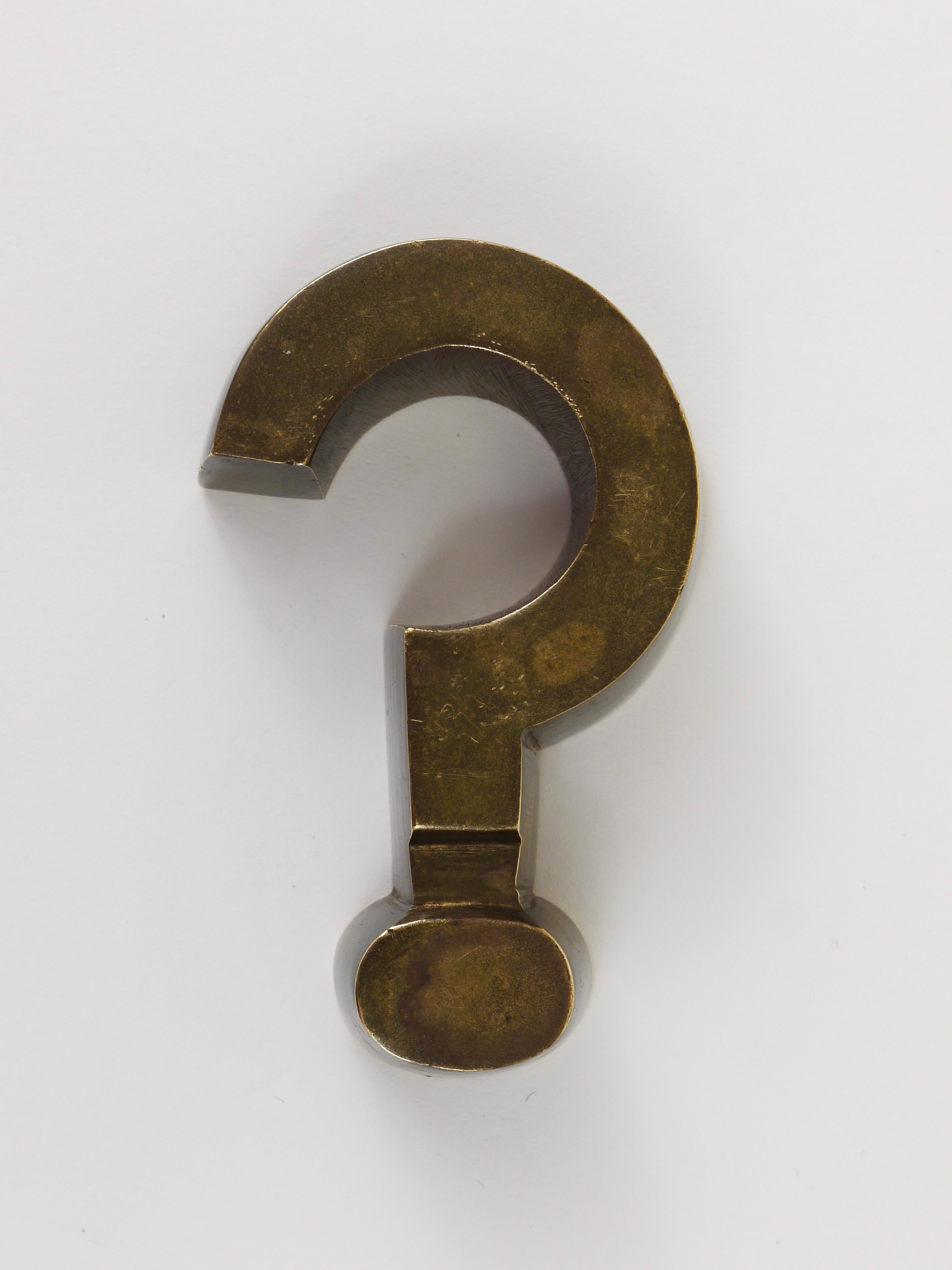 A charming and decorative paperweight in the shape of a question mark from the 1970s. Made of solid brass, in good condition with nice patina.