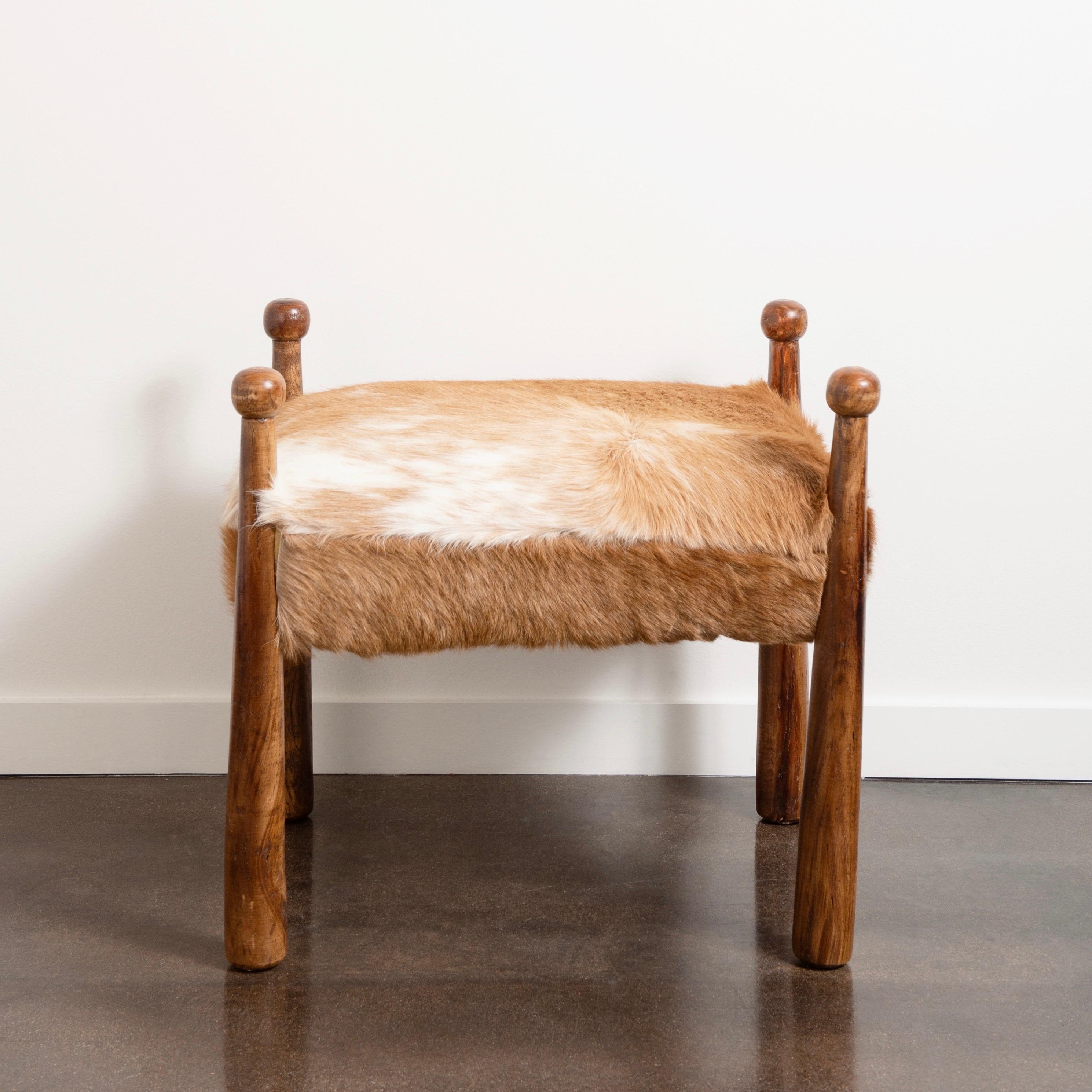 “Quilles’ style cowhide stool in the manner of Jean Royère. The piece was acquired in great condition allowing us to keep the original cowhide upholstery. Beautifully proportioned, this stool is the perfect accent piece to any room.