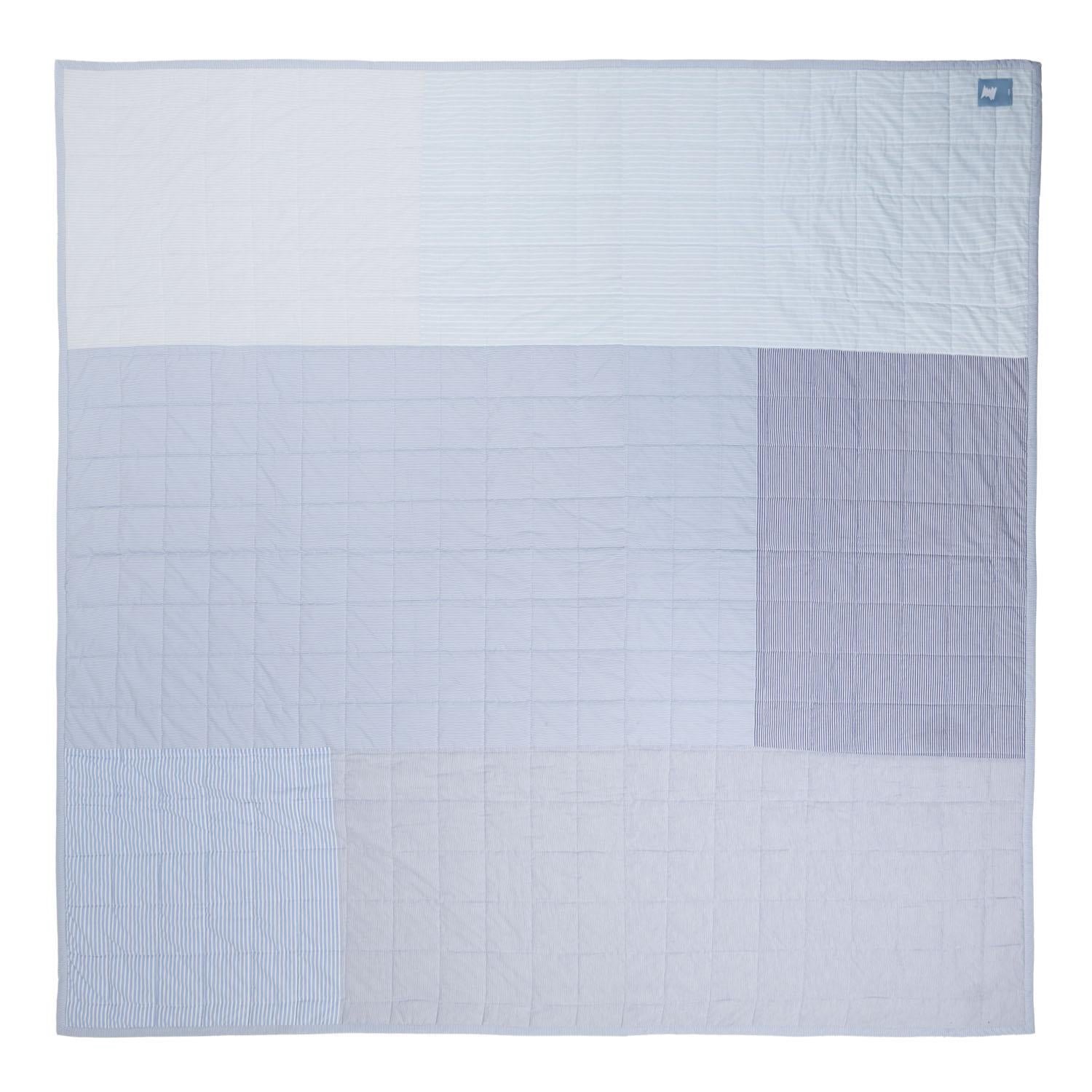 This quilted patchwork throw features a medley of blues from soft sky to deep denim, along with white and gradients of gray.
Each padded panel possess unique striped patterns that feel sweetly familiar and timeless. 
Made with remnant patches of