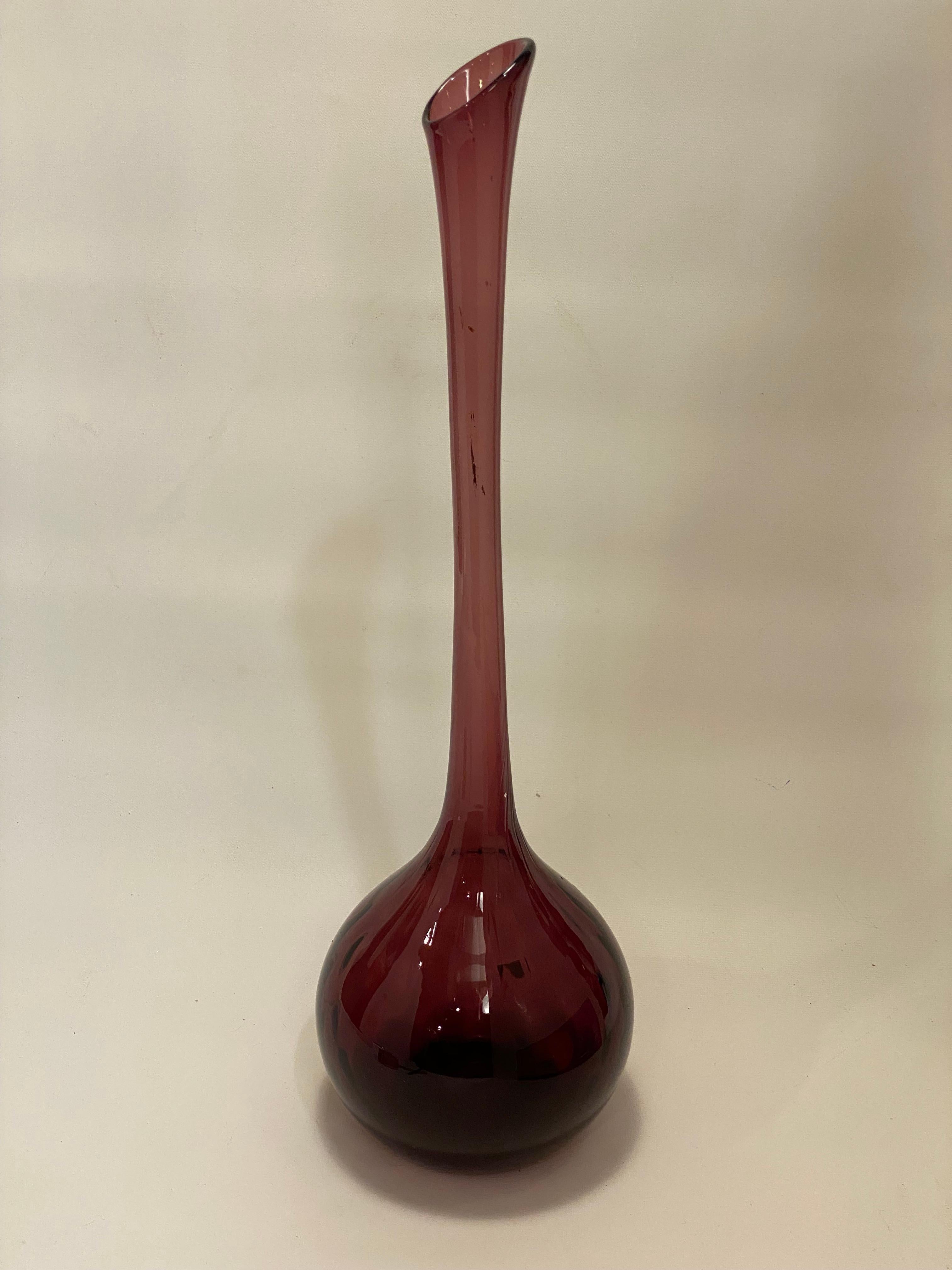 Tall and elegant Empoli blown glass vase. Interior quilted pattern bulbous base with a long flared neck and mouth. Deep purple color with polished bottom. Circa 1960-70. Partial intact label. Good overall condition with no visible chips or cracks.