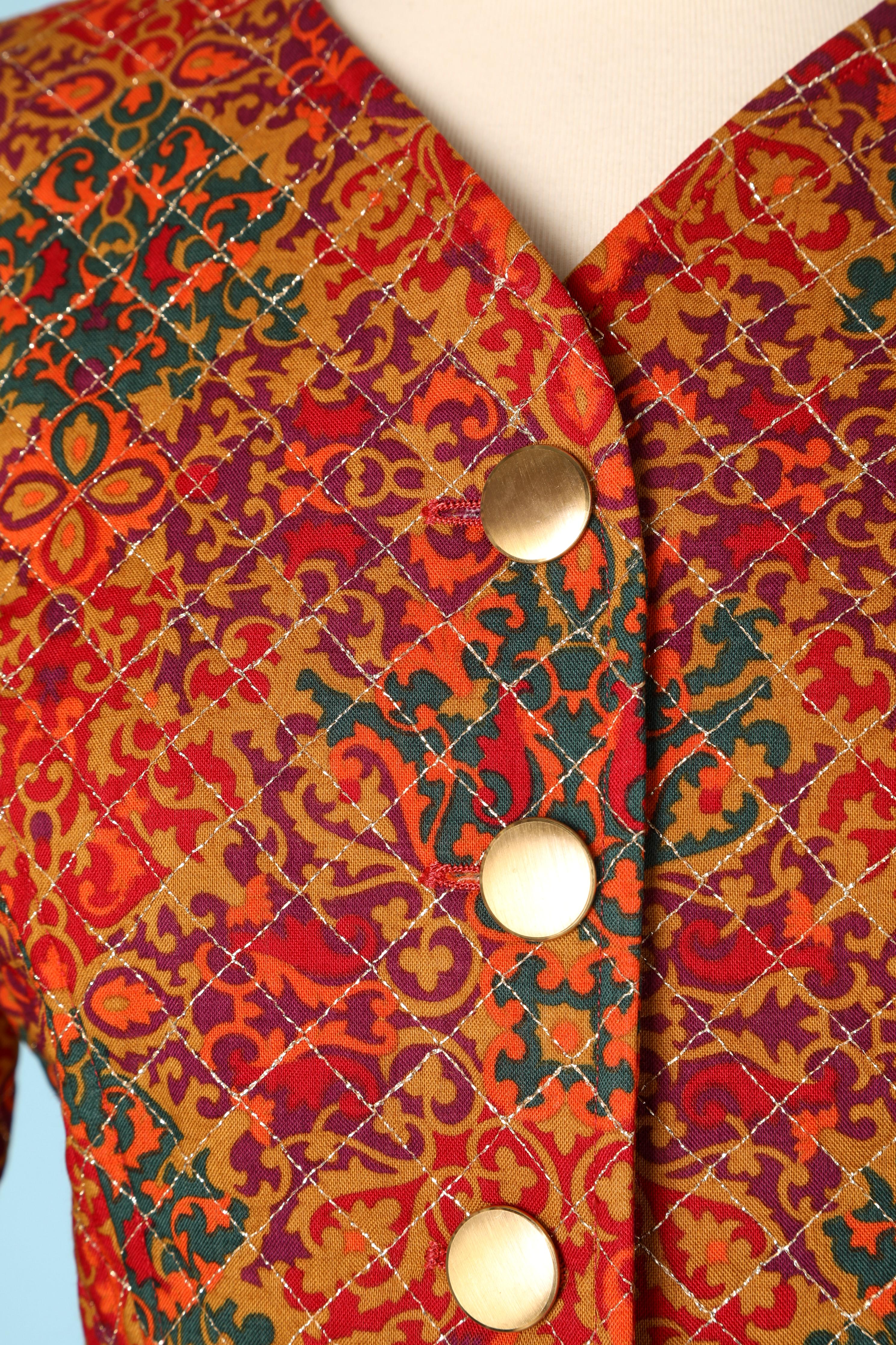 Quilted printed cotton jacket with gold lurex thread top-stitching and gold metal buttons.
Copper satin lining.