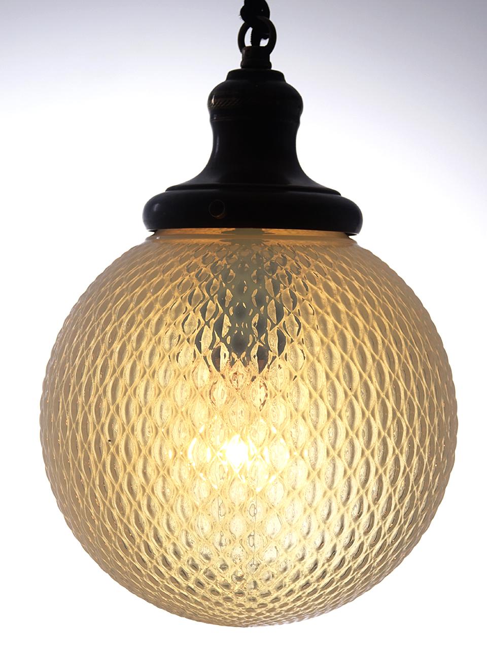 This glass is part vaseline and part opeline. The color and quilt pattern give this pendant a unique look. The shade holder has a period Japanned finish.