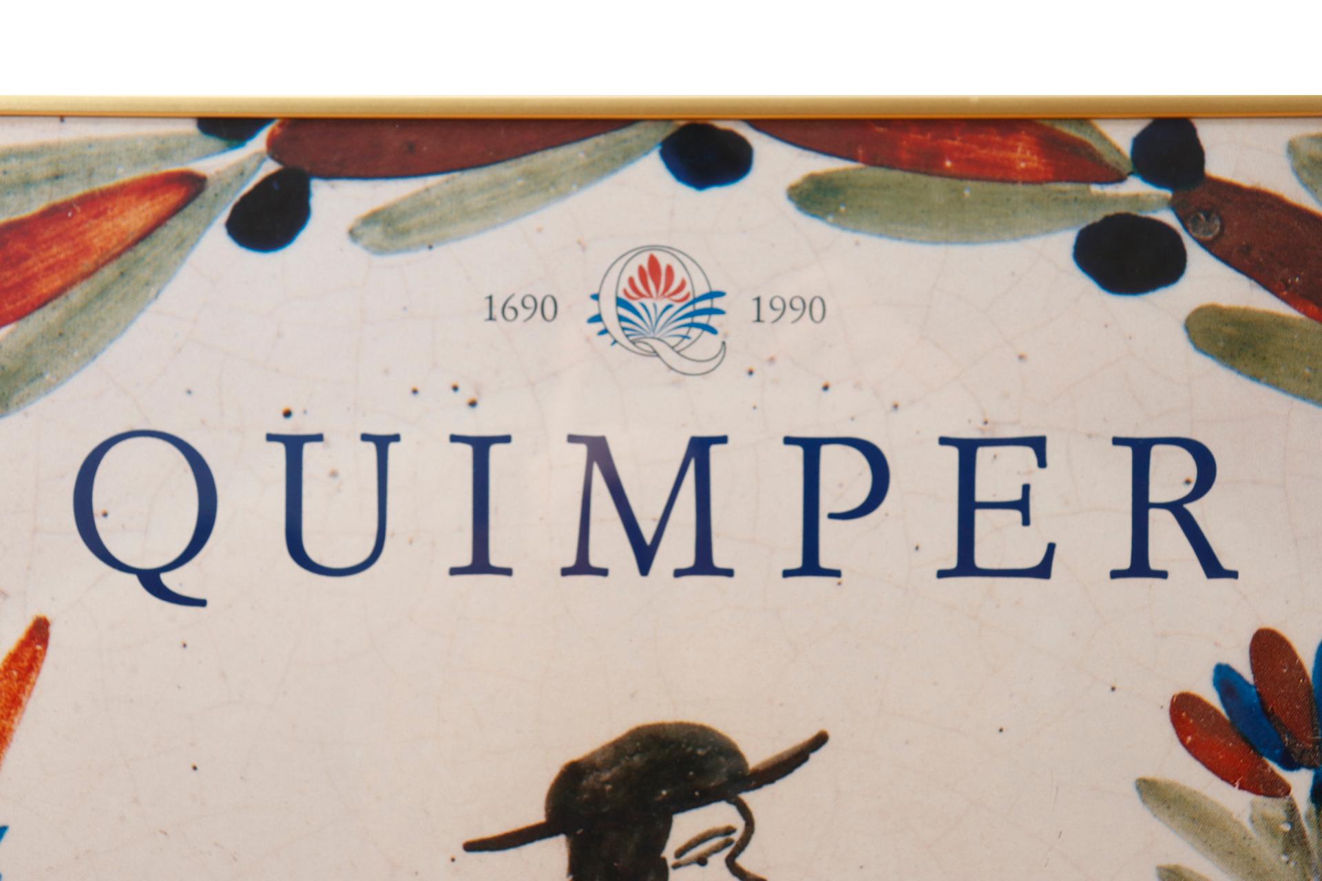 A framed lithograph poster promoting an exhibition at the Musée des Beaux-Arts celebrating three centuries of Quimper Faïence, May through September in 1990. The poster depicts a “Petit Breton” peasant framed with blue, red and green leaves in a
