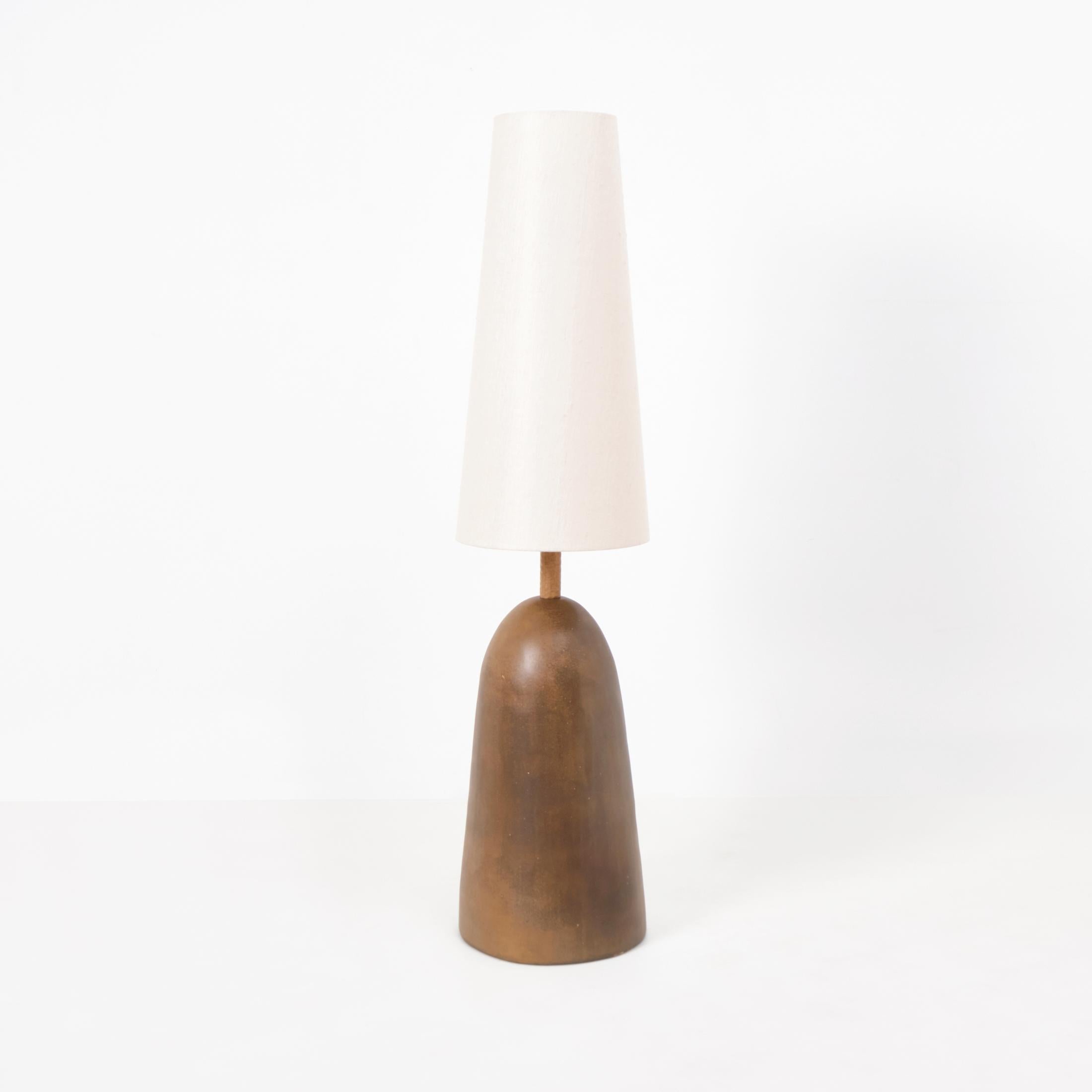 QUINTA FLOOR LIGHT, designed in 2025.

Large artisanal foor light made in Project 213A's own workshop. This piece has a hand-crafted ceramic base with a custom glaze finish. The lampshade stem is made from solid wood and finsihed in a hand gouged
