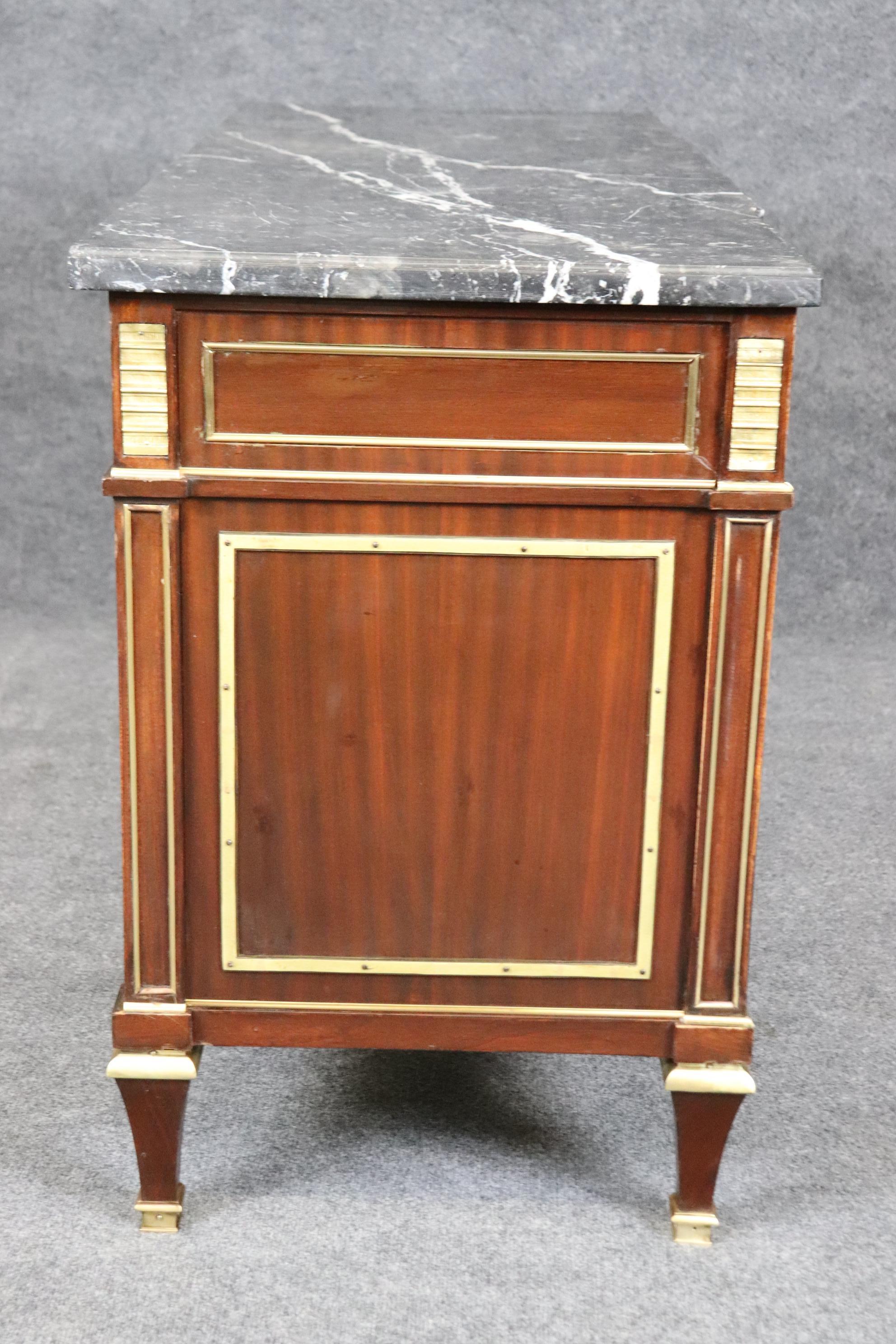 This is a quintessential signed Maison Jansen bronze mounted marble top commode or dresser. The look, design and overal proportions make this easily the prettiest commode online today. The condition is original with gorgeous bronze and ring pulls.