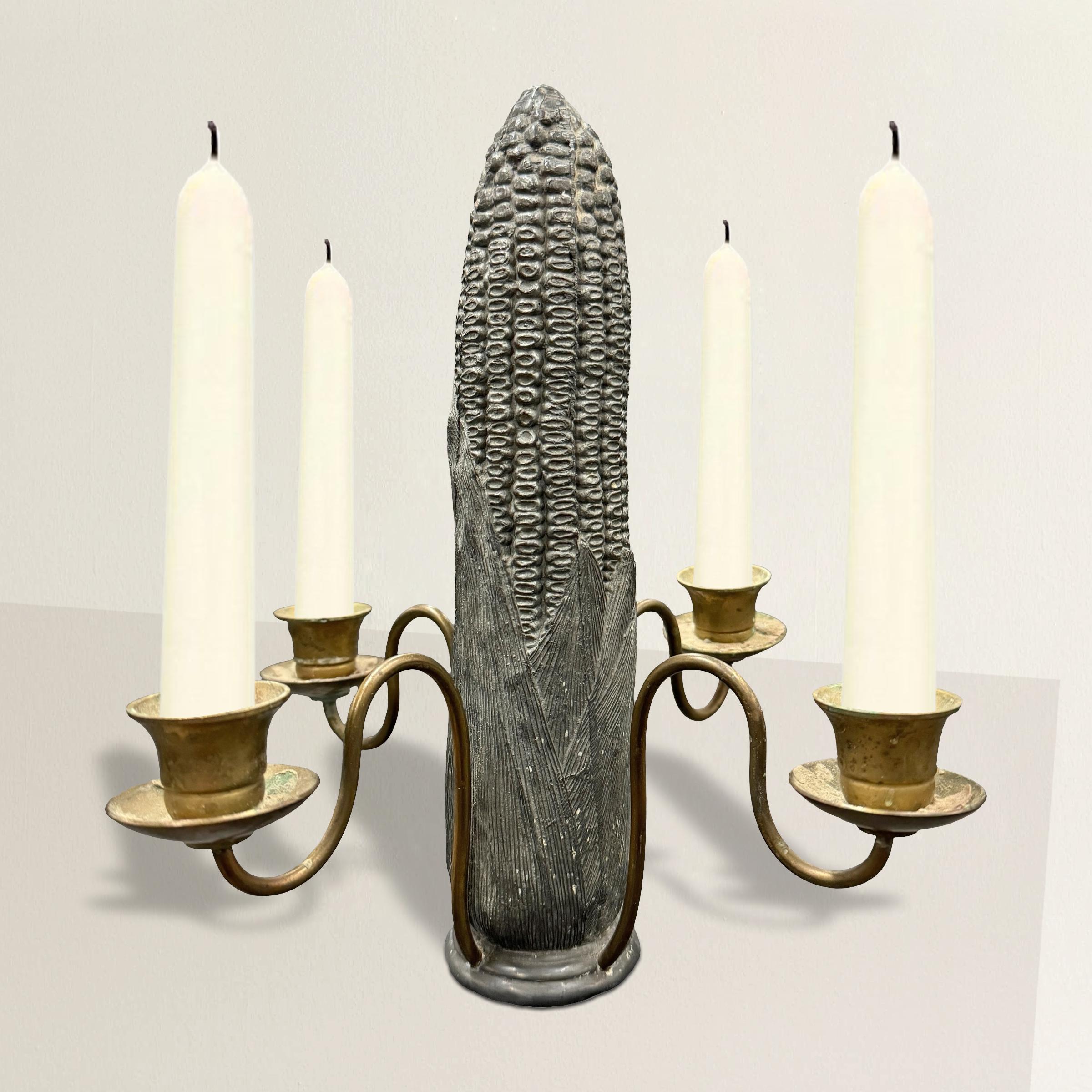 This mid-20th-century American solid pewter corncob candelabra with four brass arms is a marvel of quirky design. Crafted with meticulous attention to detail, it stands as a testament to the creativity and ingenuity of its maker. Its unusual